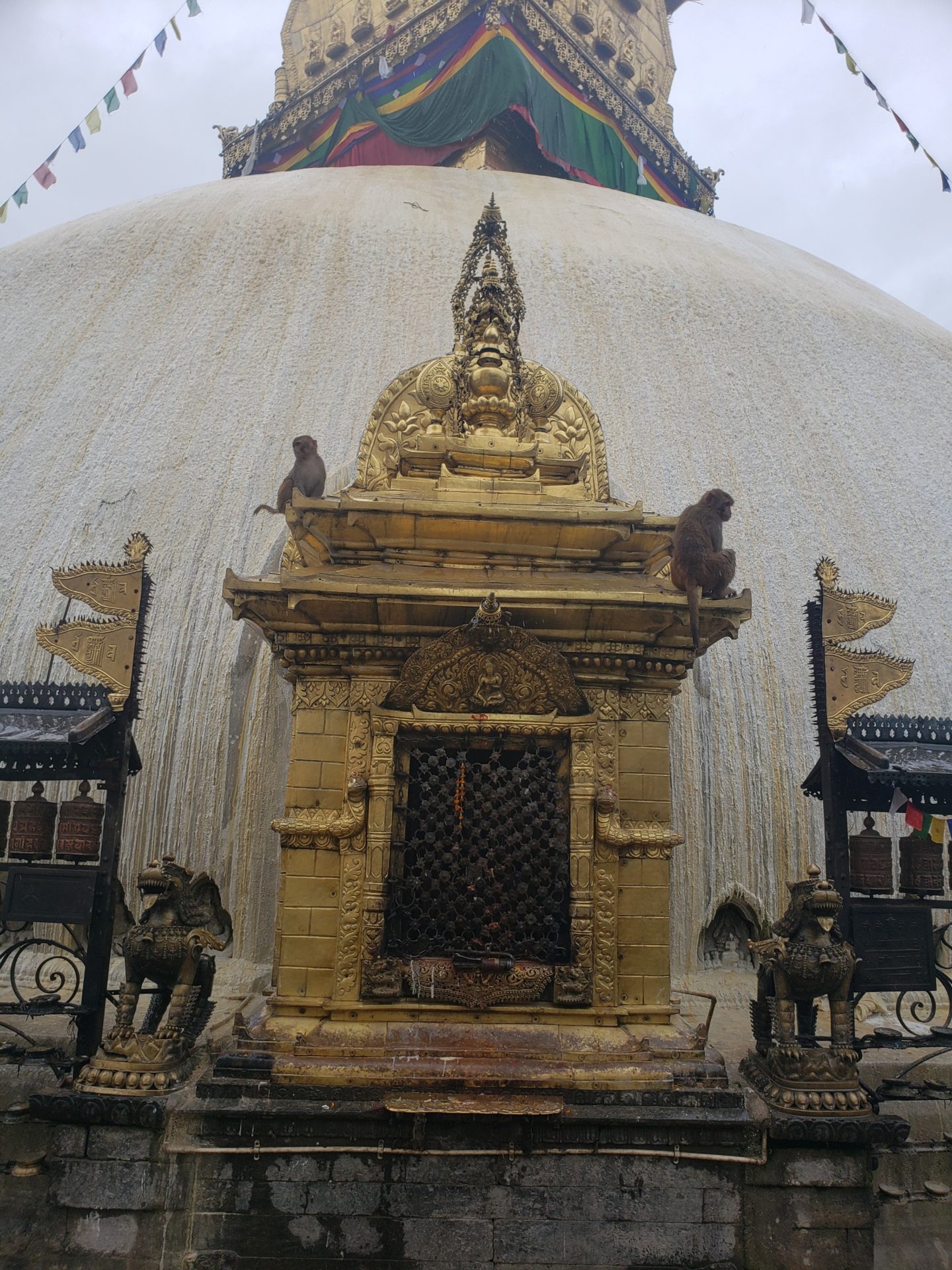a gold temple with monkeys on top of it