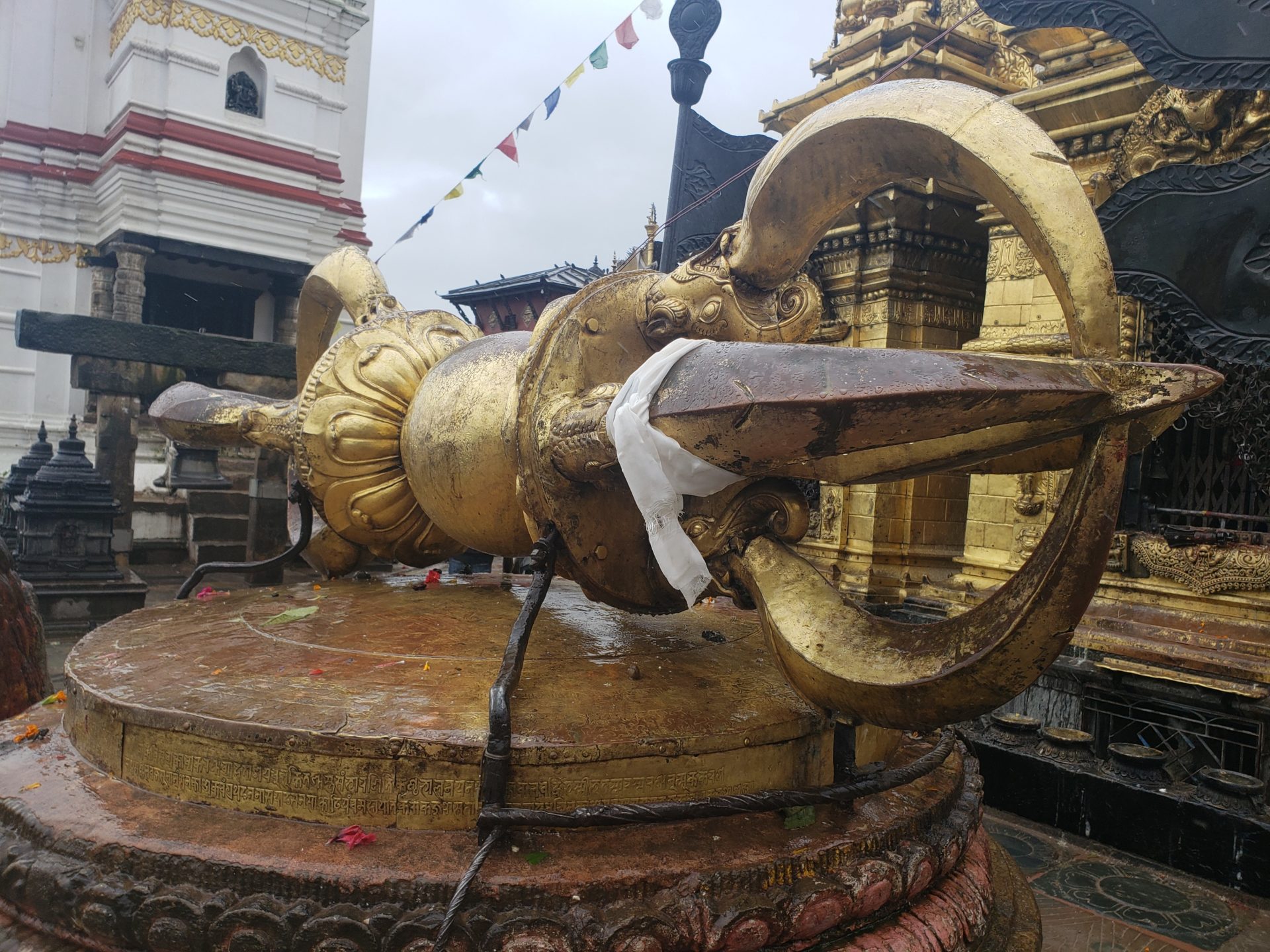 a large gold statue with a large blade