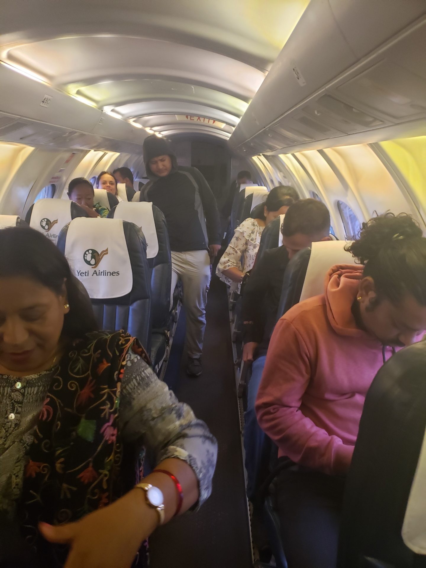 a group of people sitting on seats in an airplane
