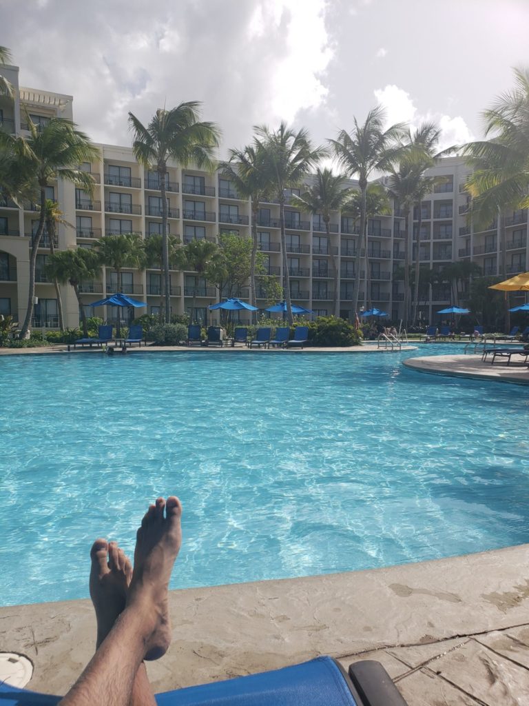 a person's feet in front of a pool