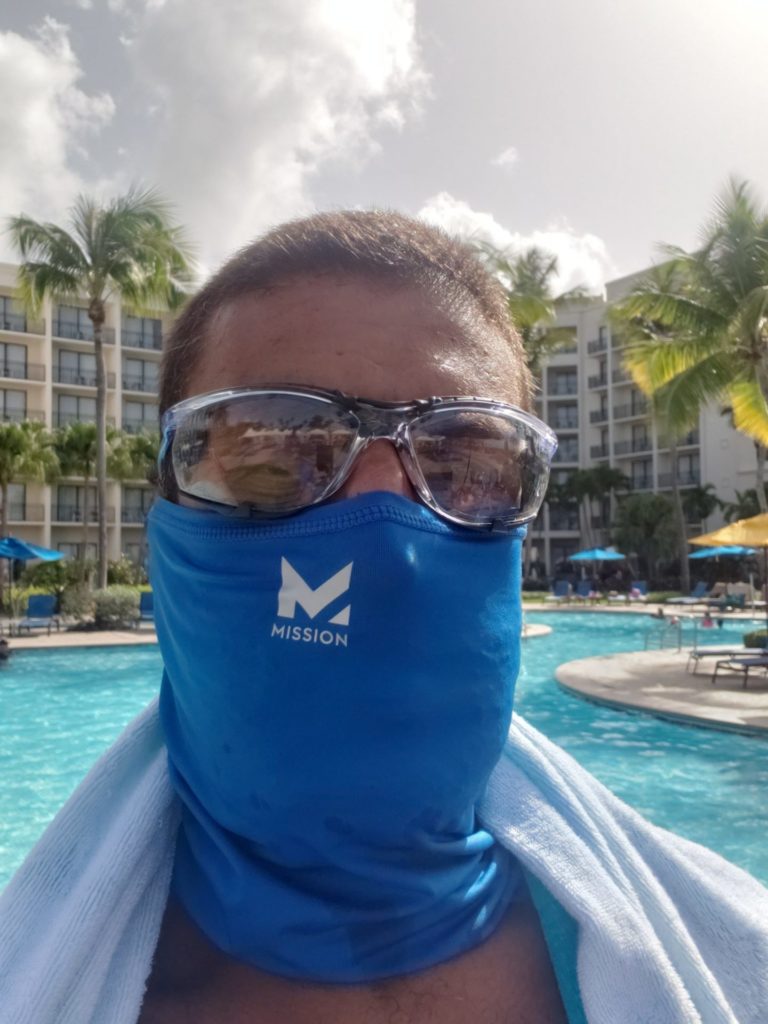 a man wearing a face mask and sunglasses