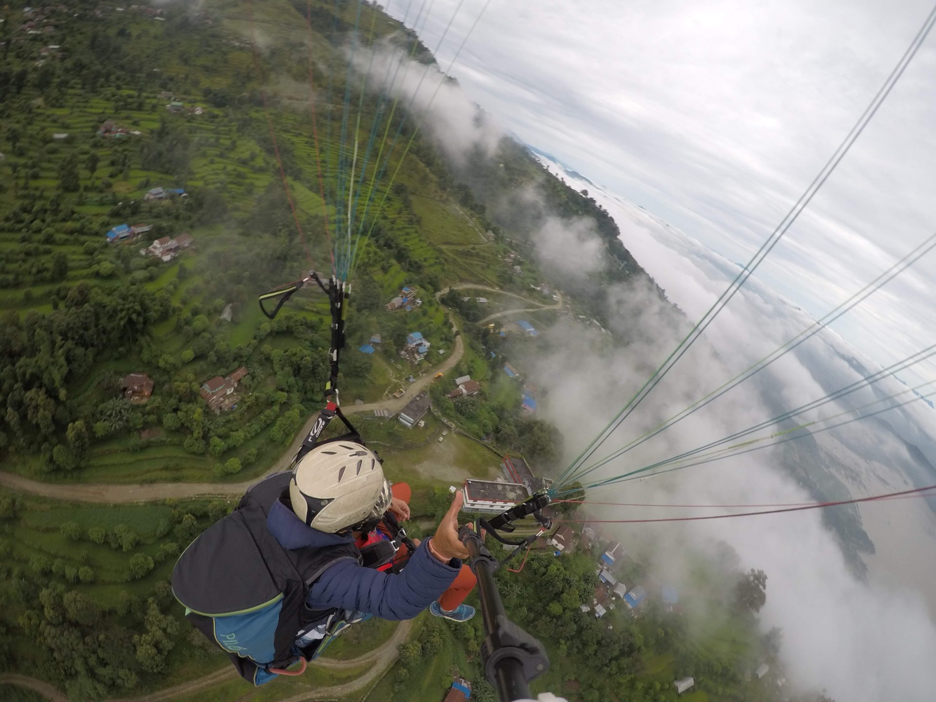 a person paragliding over a valley