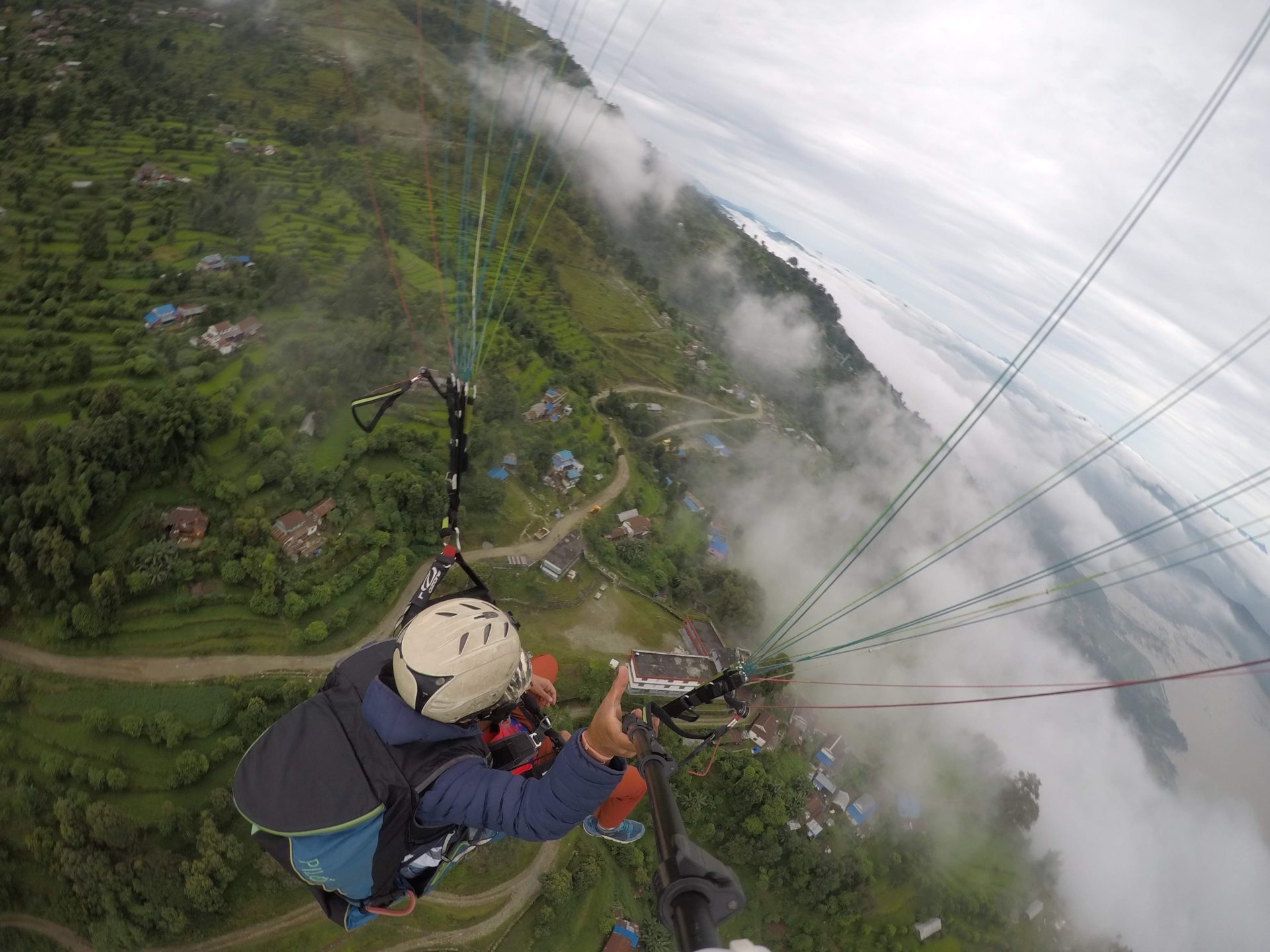 a person flying with parachutes