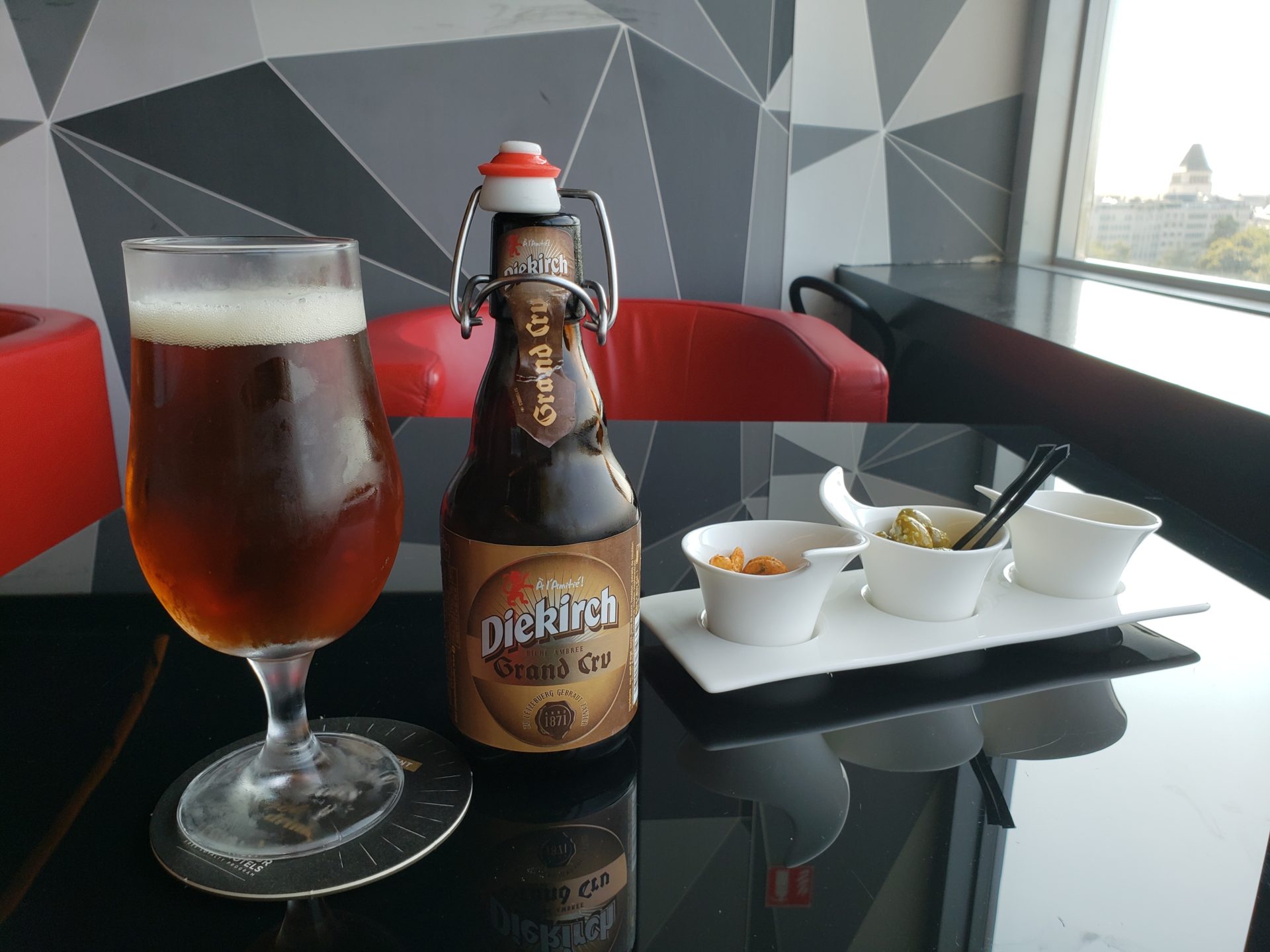 a glass of beer and a bottle of beer on a table