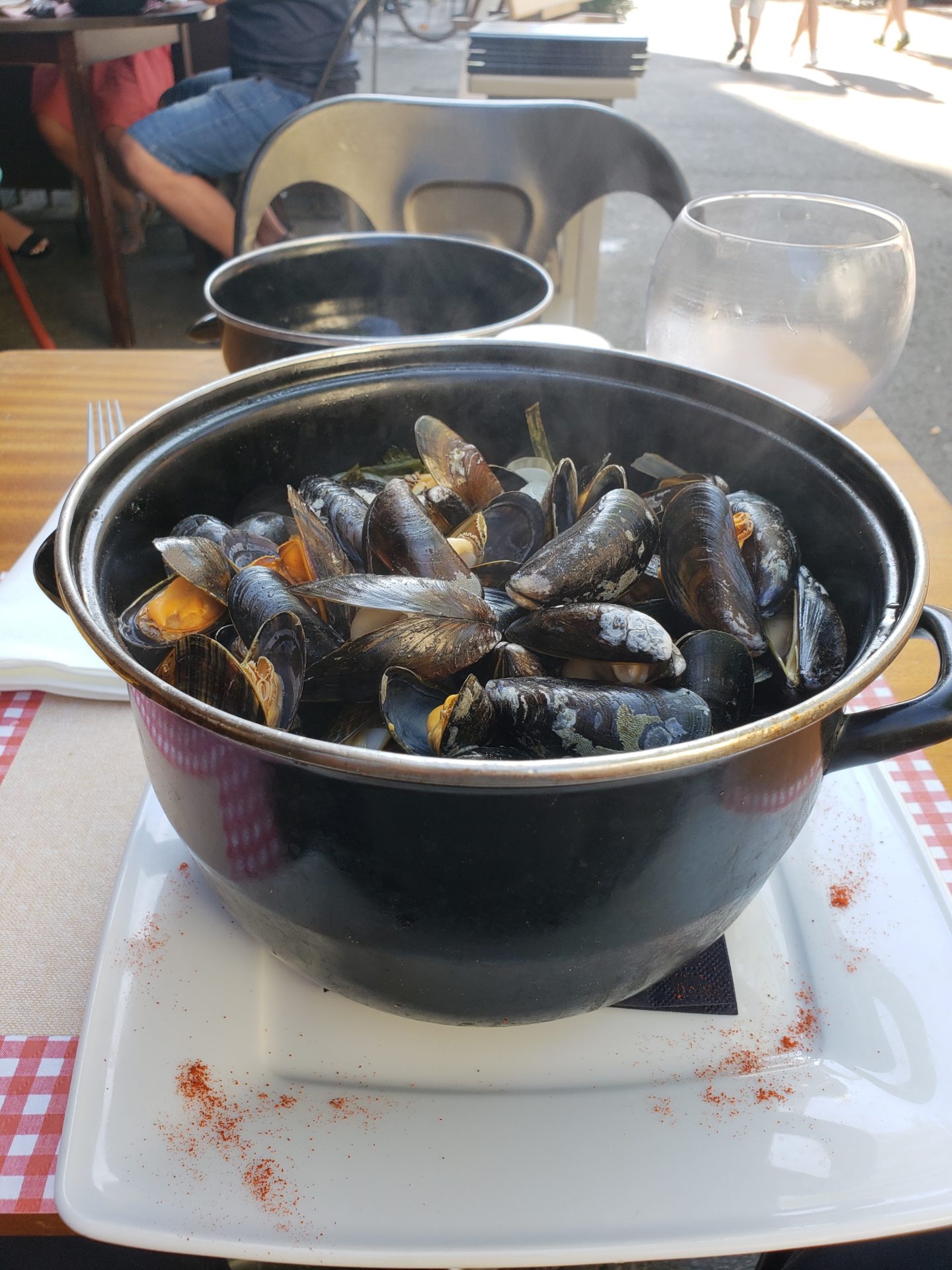 a pot of mussels on a table