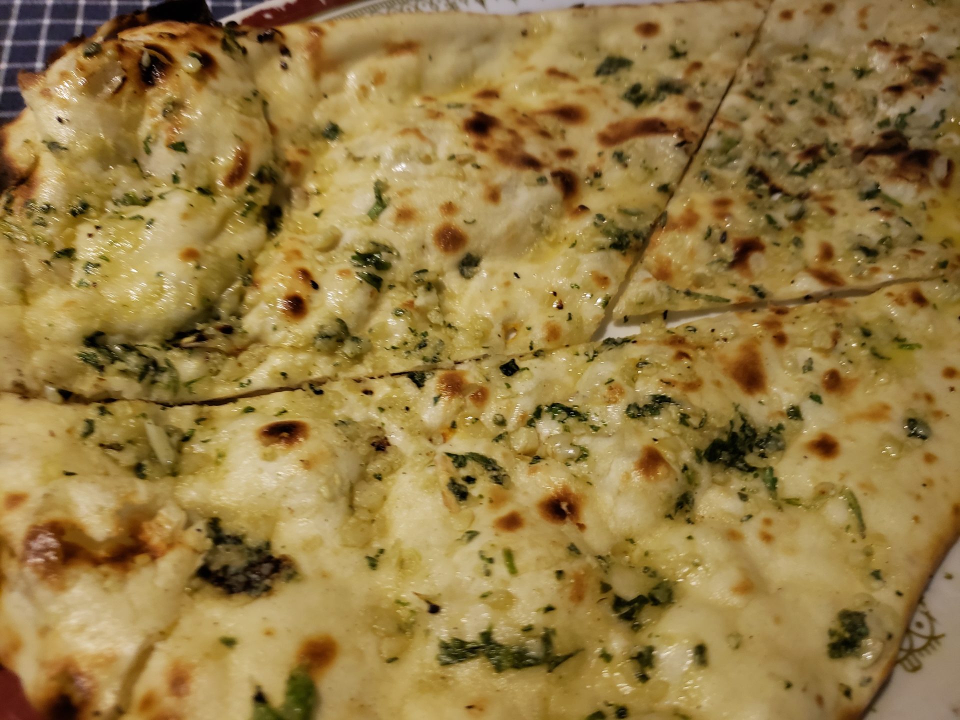 a pizza with cheese and herbs