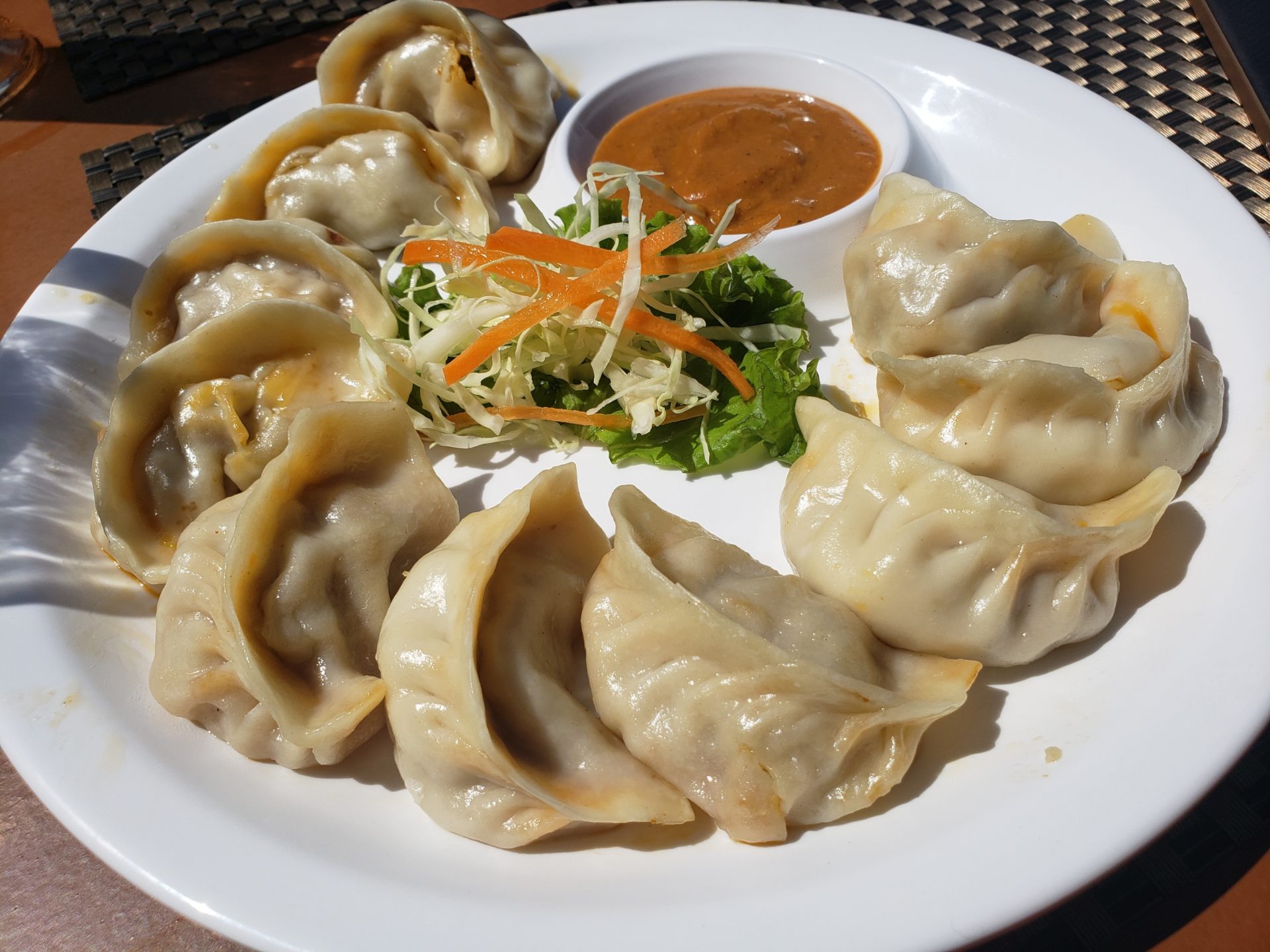 a plate of dumplings with sauce