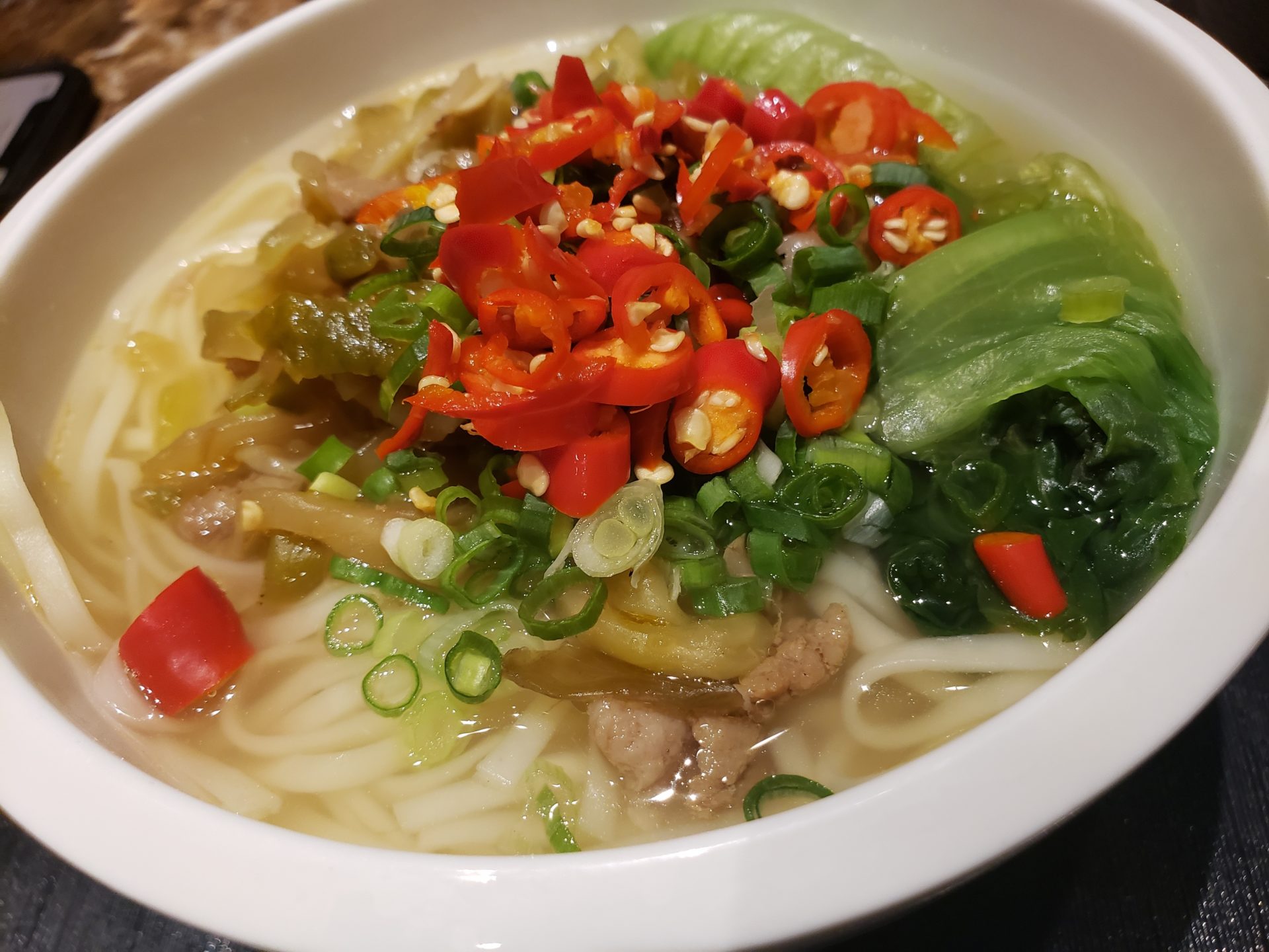 a bowl of soup with vegetables and noodles
