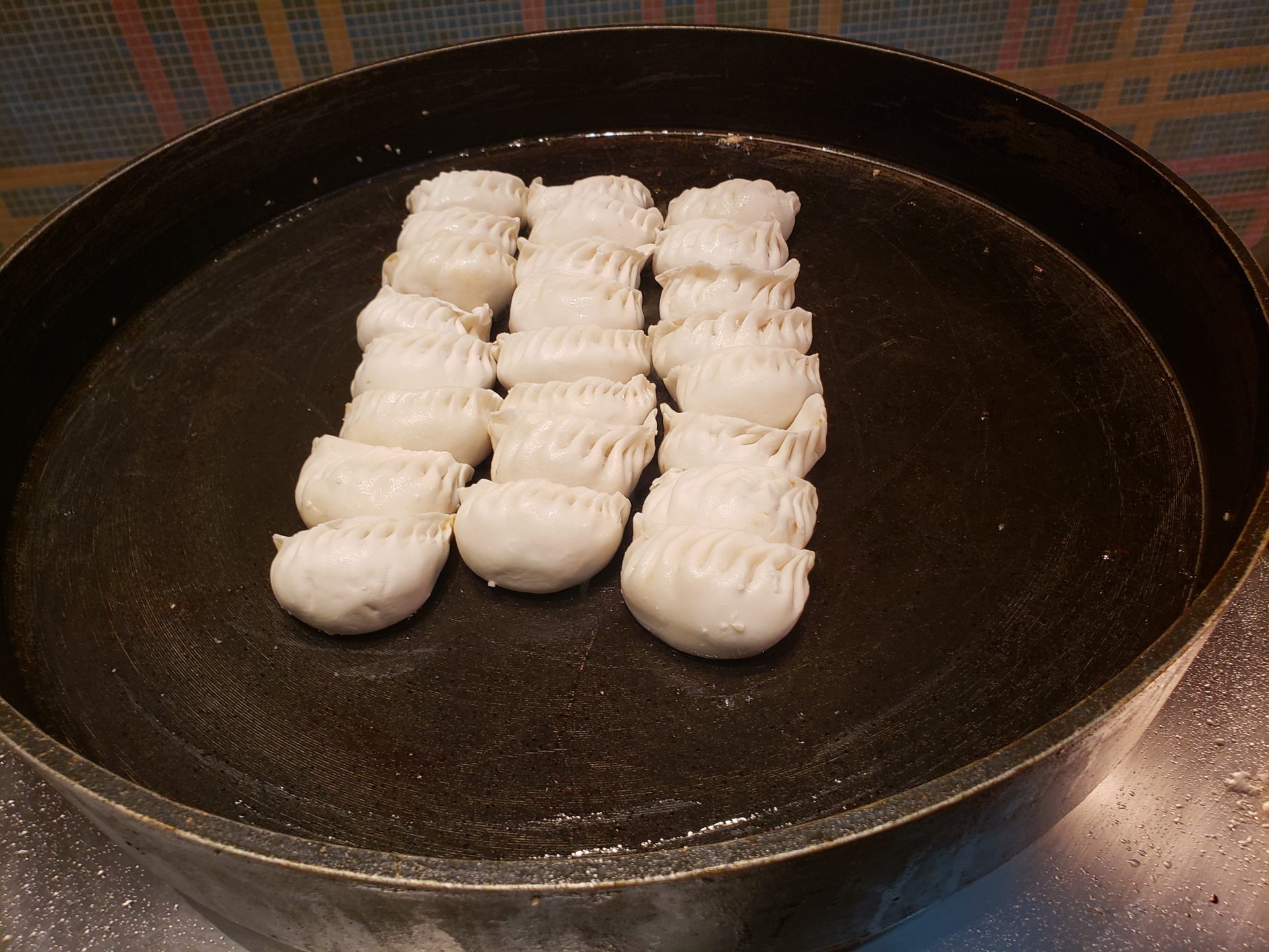 a pan of dumplings on a stove