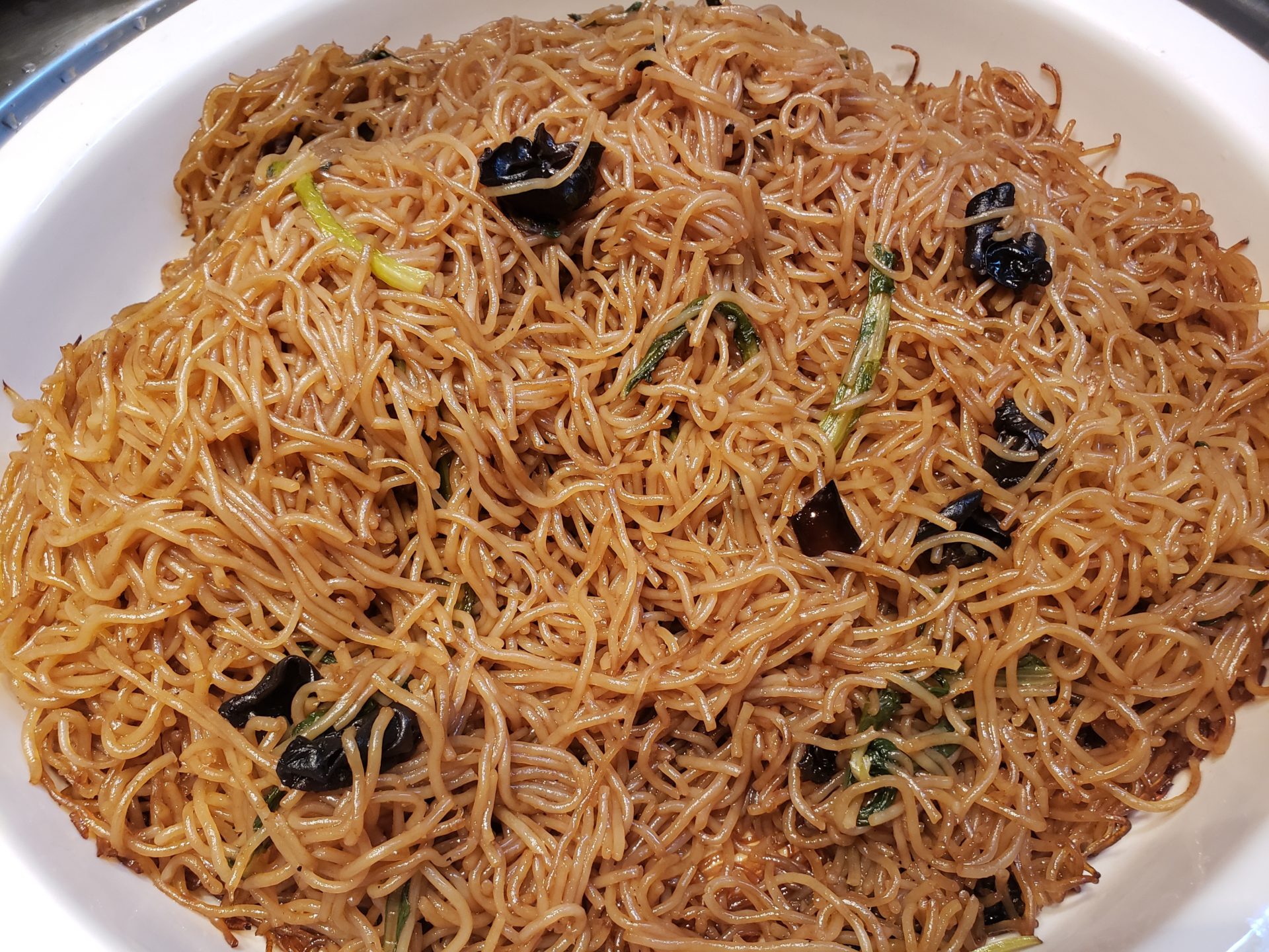 a bowl of noodles with olives