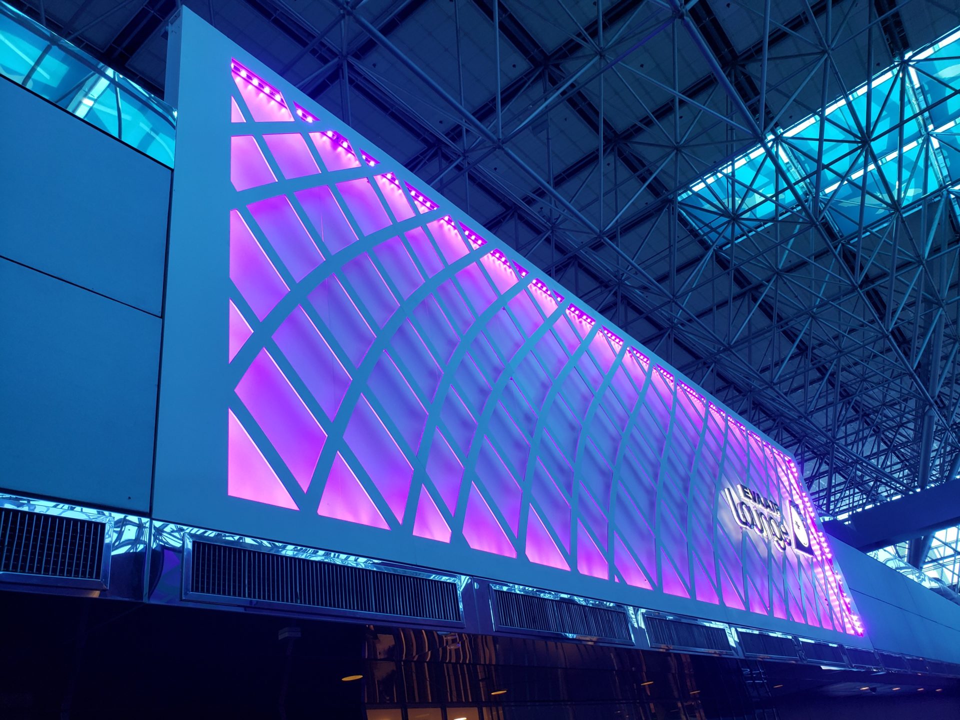 a large rectangular sign with purple lights