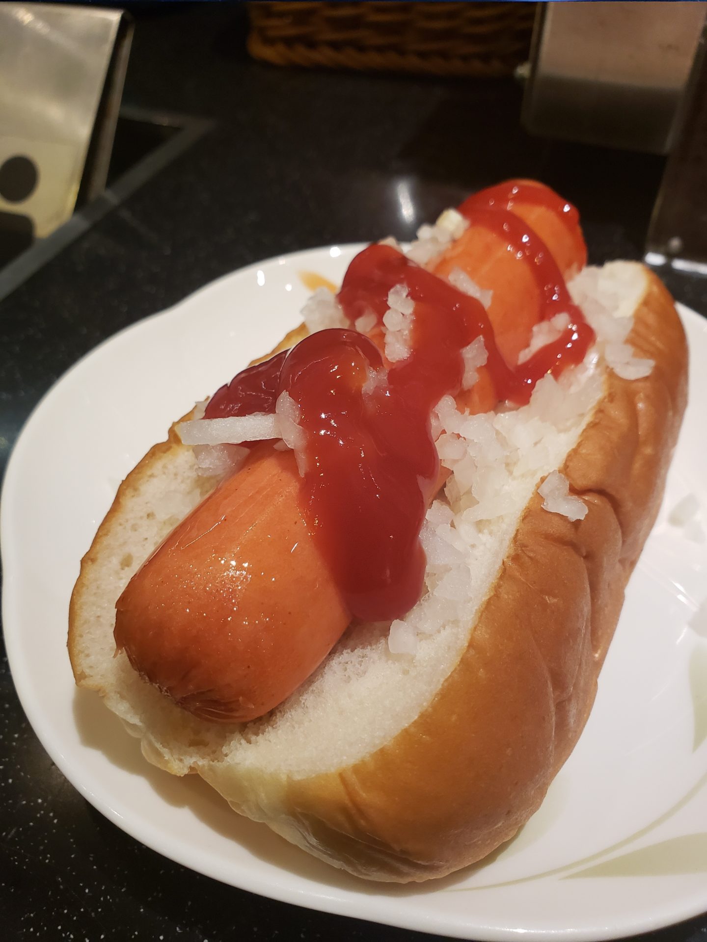 a hot dog with ketchup on top