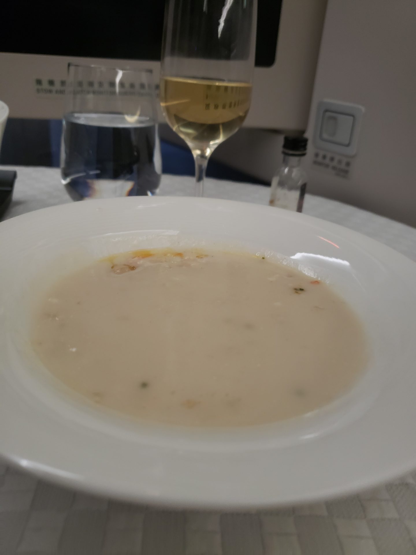 a bowl of soup and a glass of wine