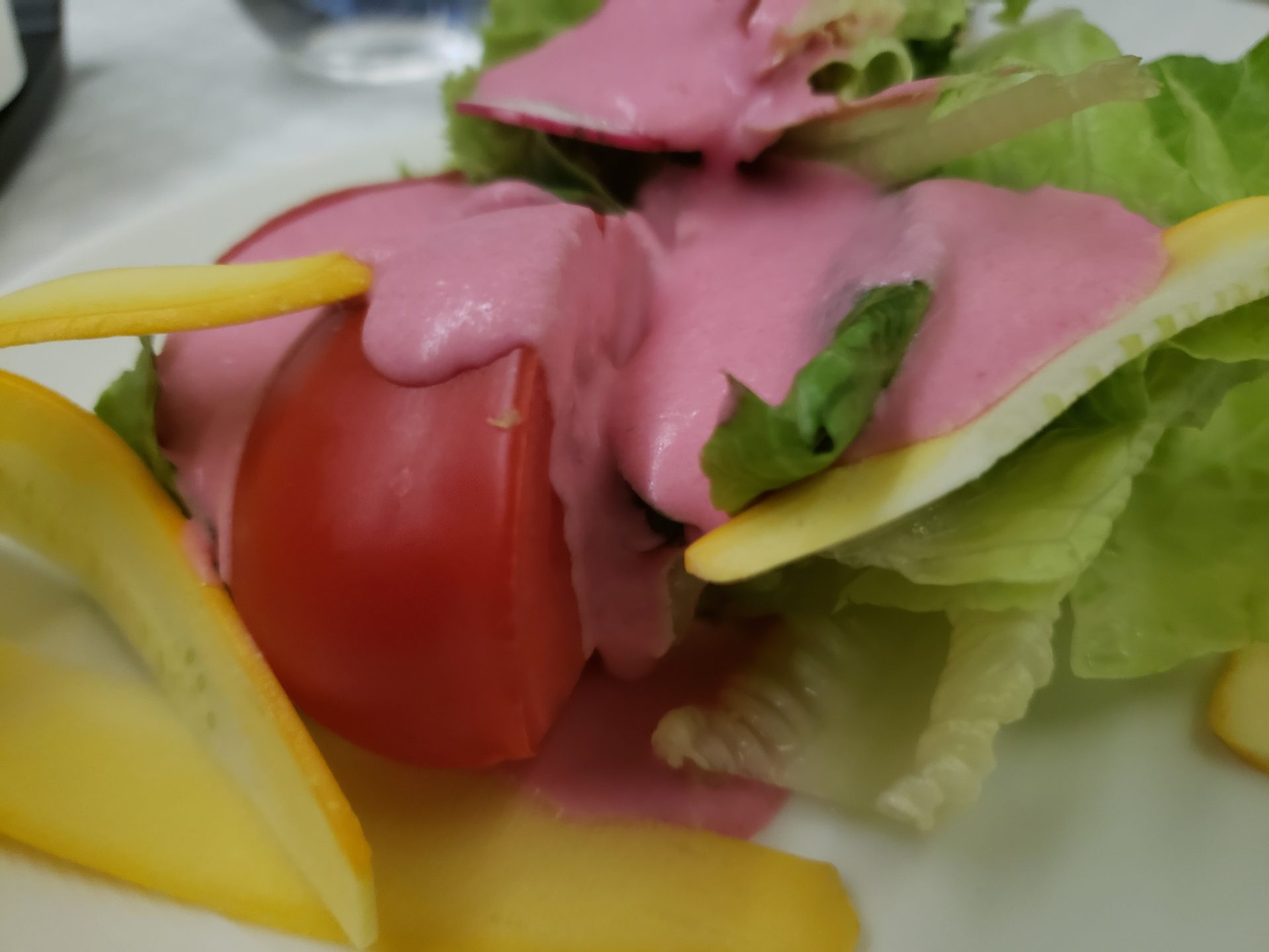 a salad with a pink sauce on it