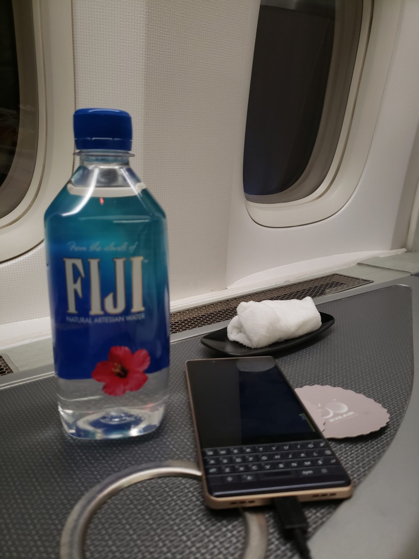 a bottle of water and a cell phone on a table
