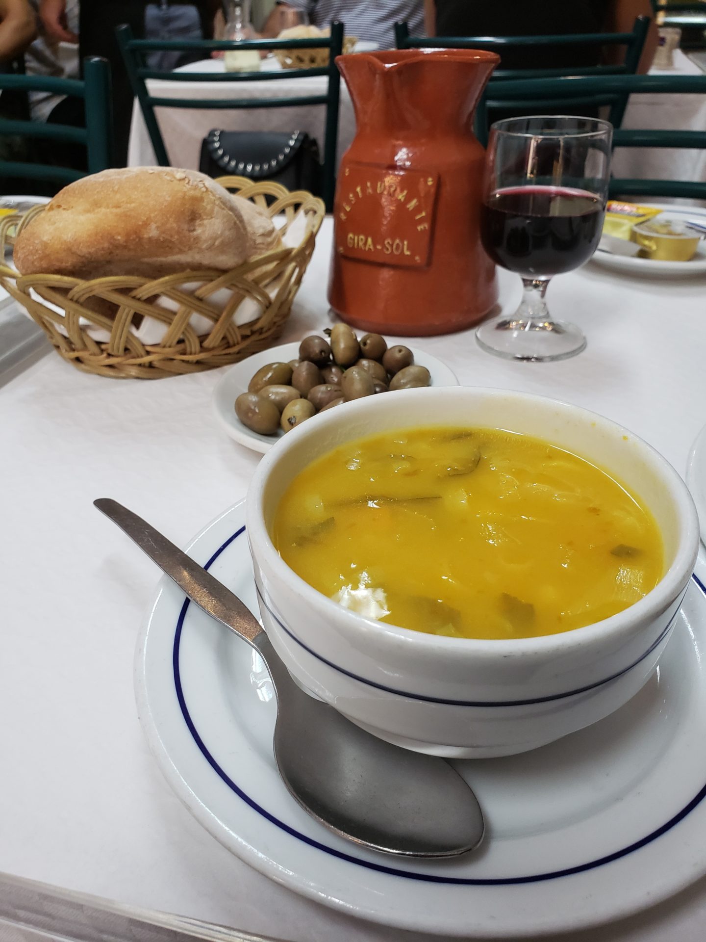 a bowl of soup and bread on a table