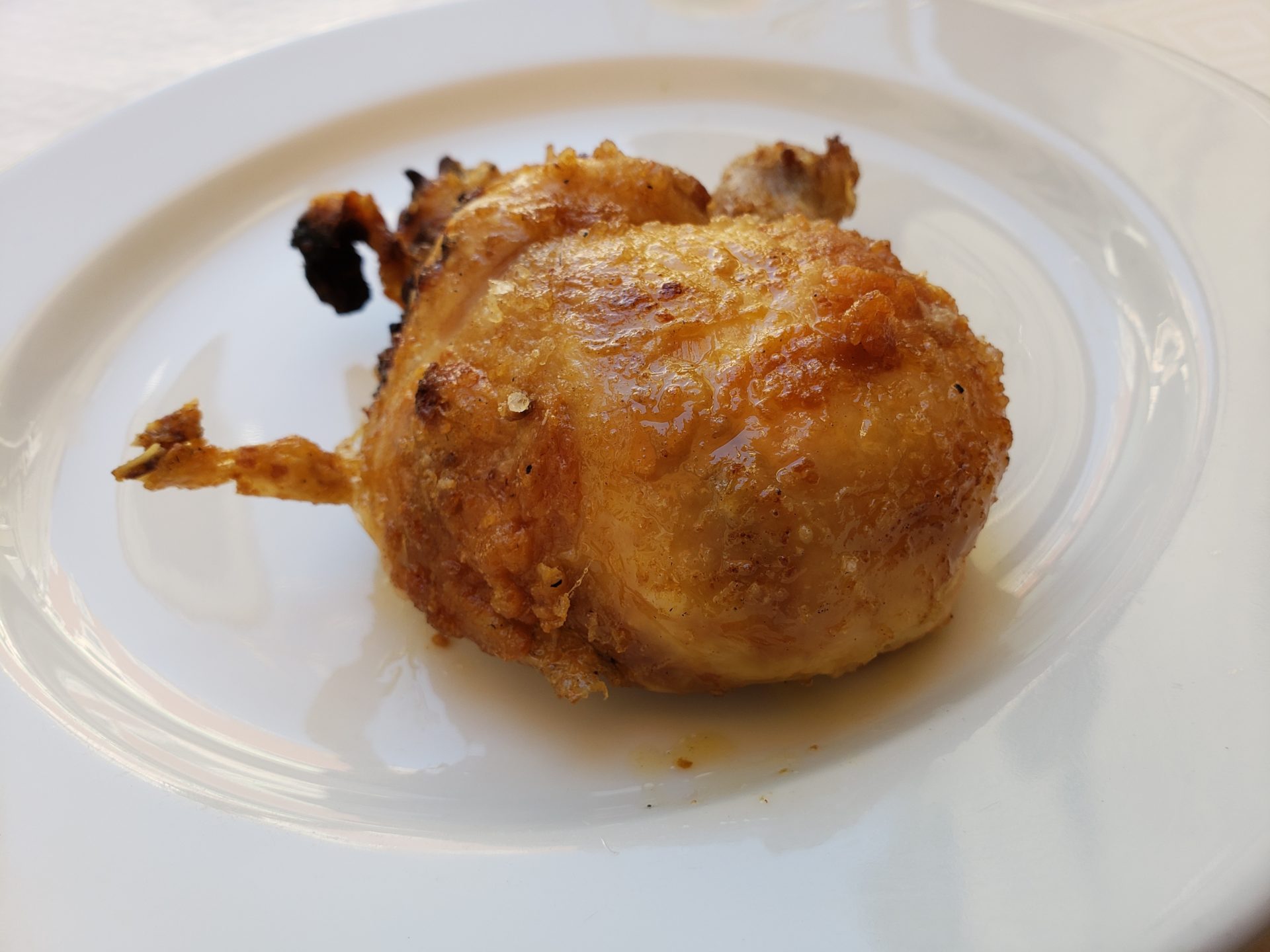 a piece of fried chicken on a white plate