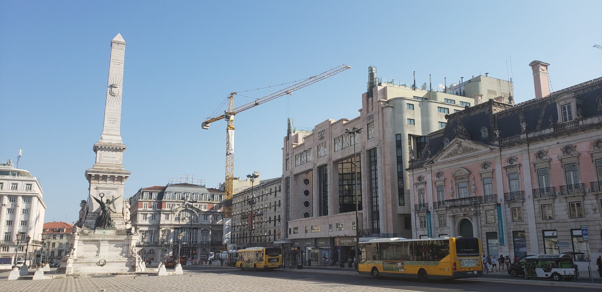 a large building with a crane in the background
