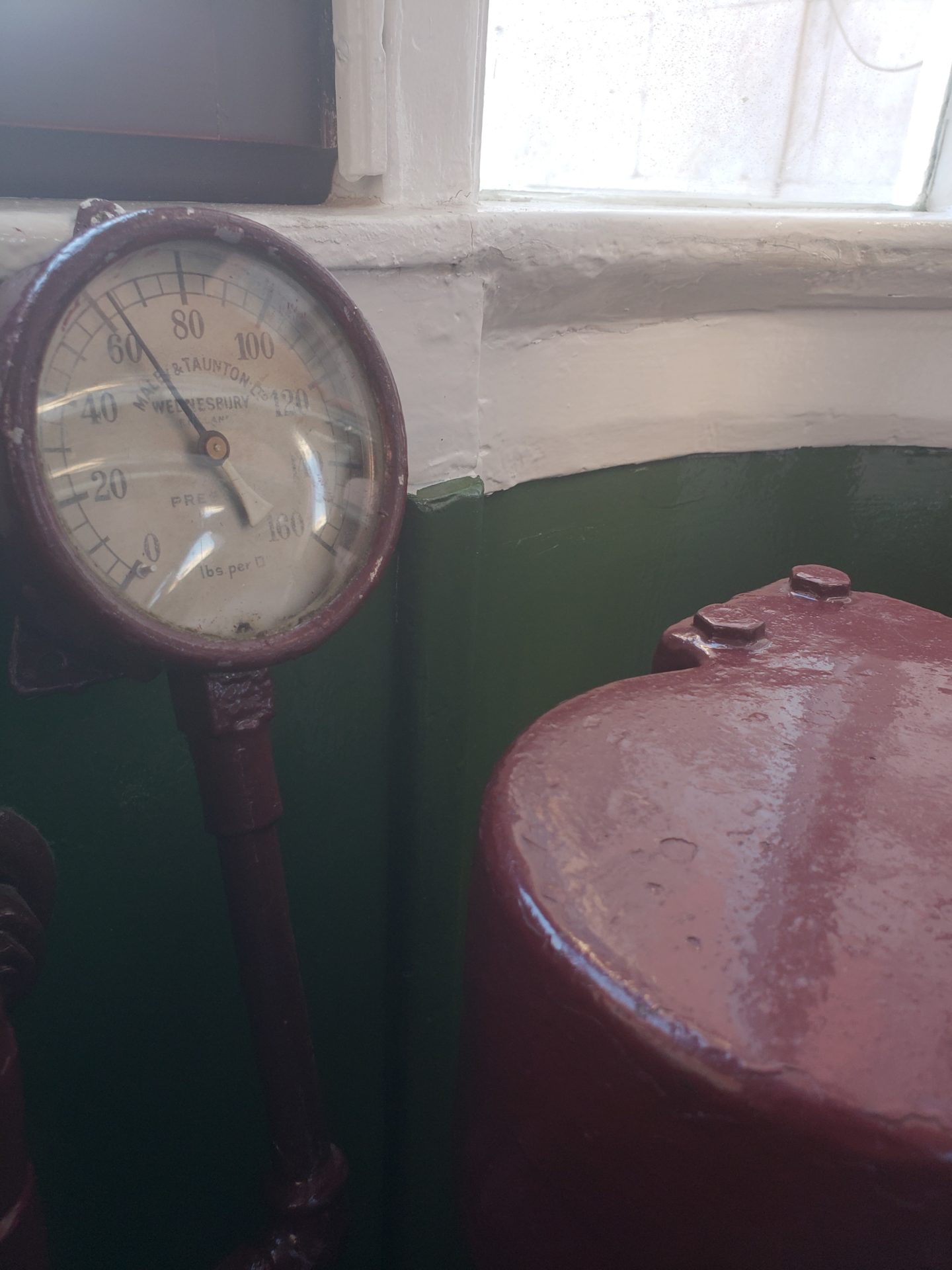 a gauge next to a red cylinder