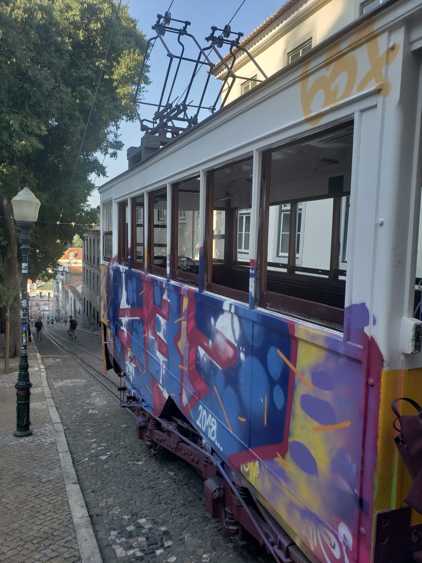 a trolley car with graffiti on it