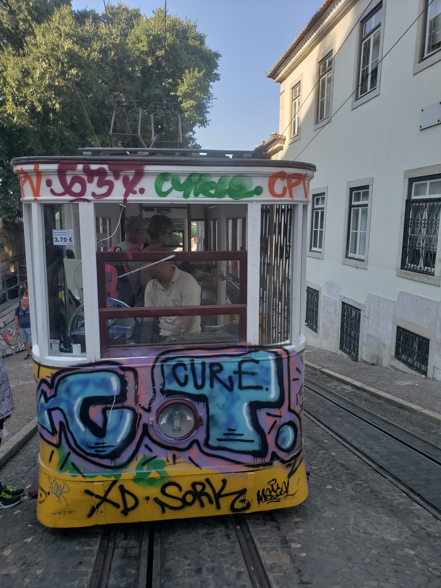 a trolley car with graffiti on it