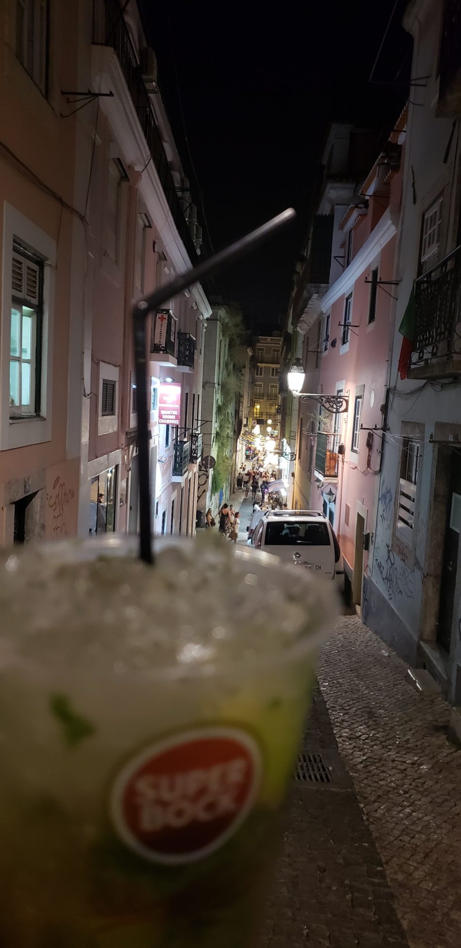 a drink in a cup on a narrow street