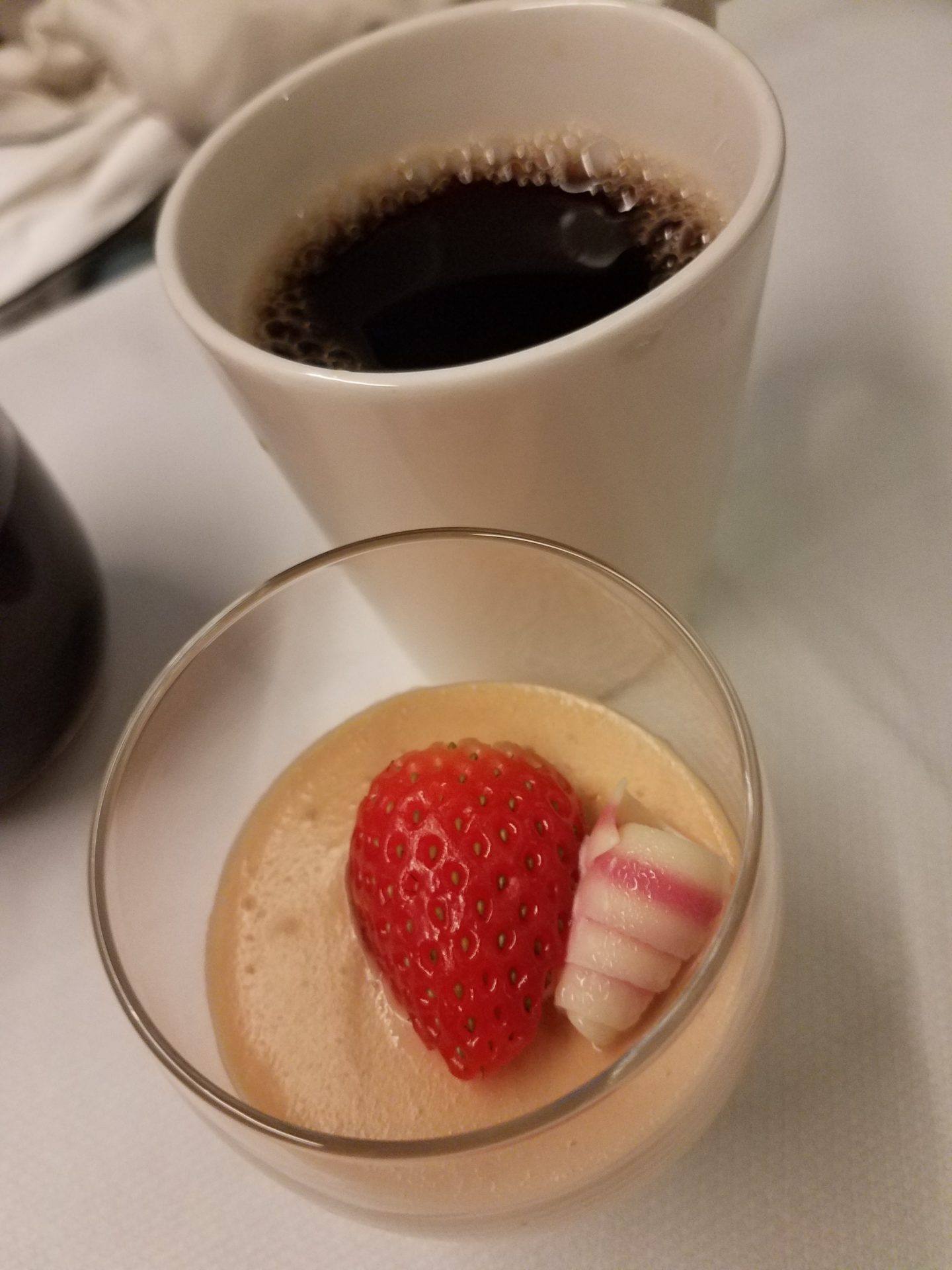 a cup of coffee and a strawberry