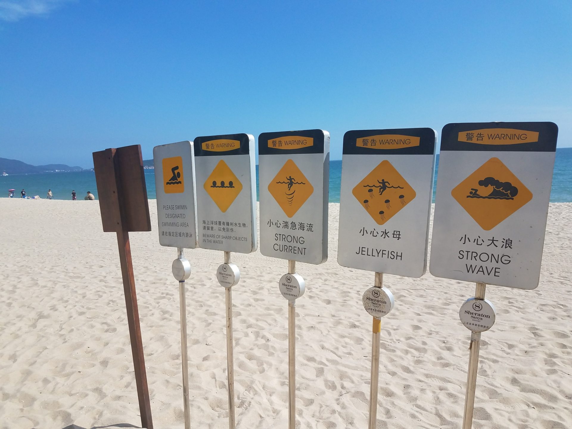 a group of signs on a beach