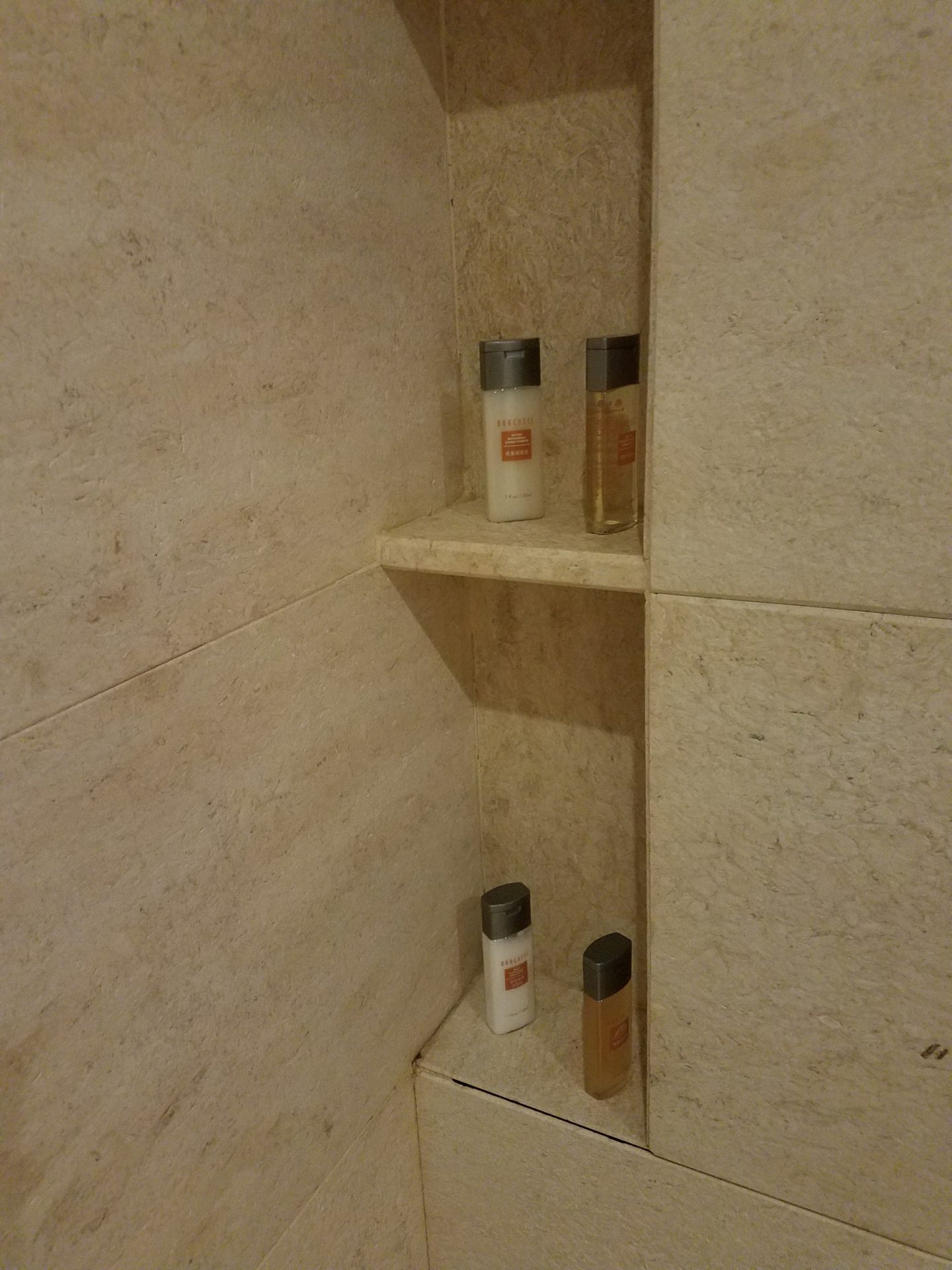 a shelf with small bottles on it
