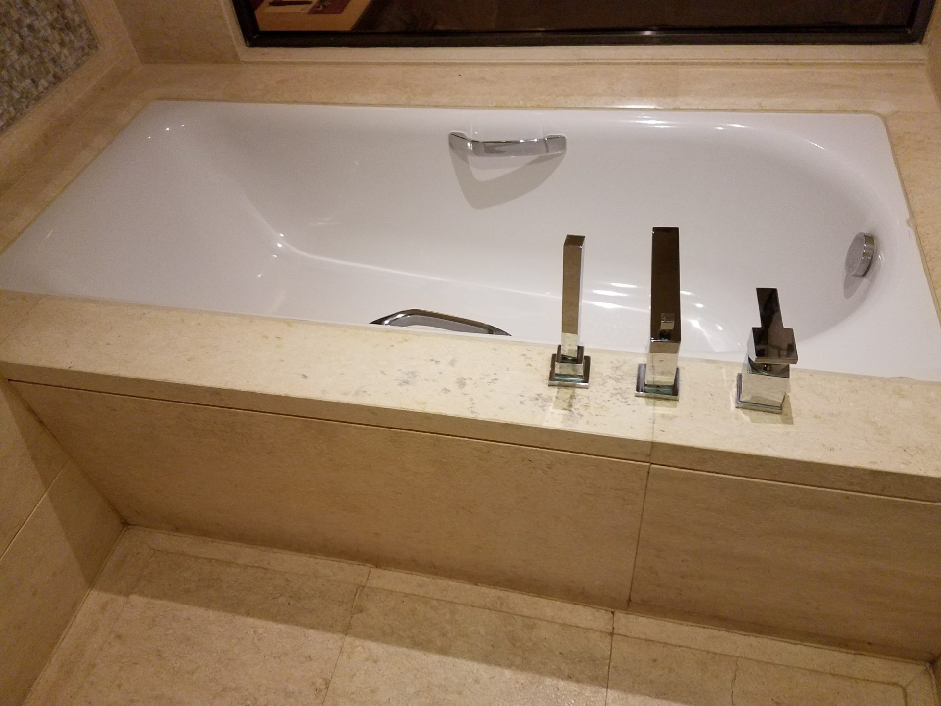 a bathtub with faucets on the side