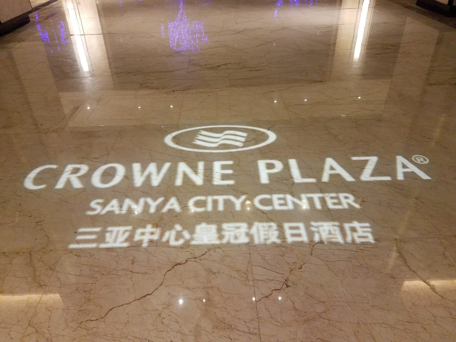 a reflection of a logo on a marble floor