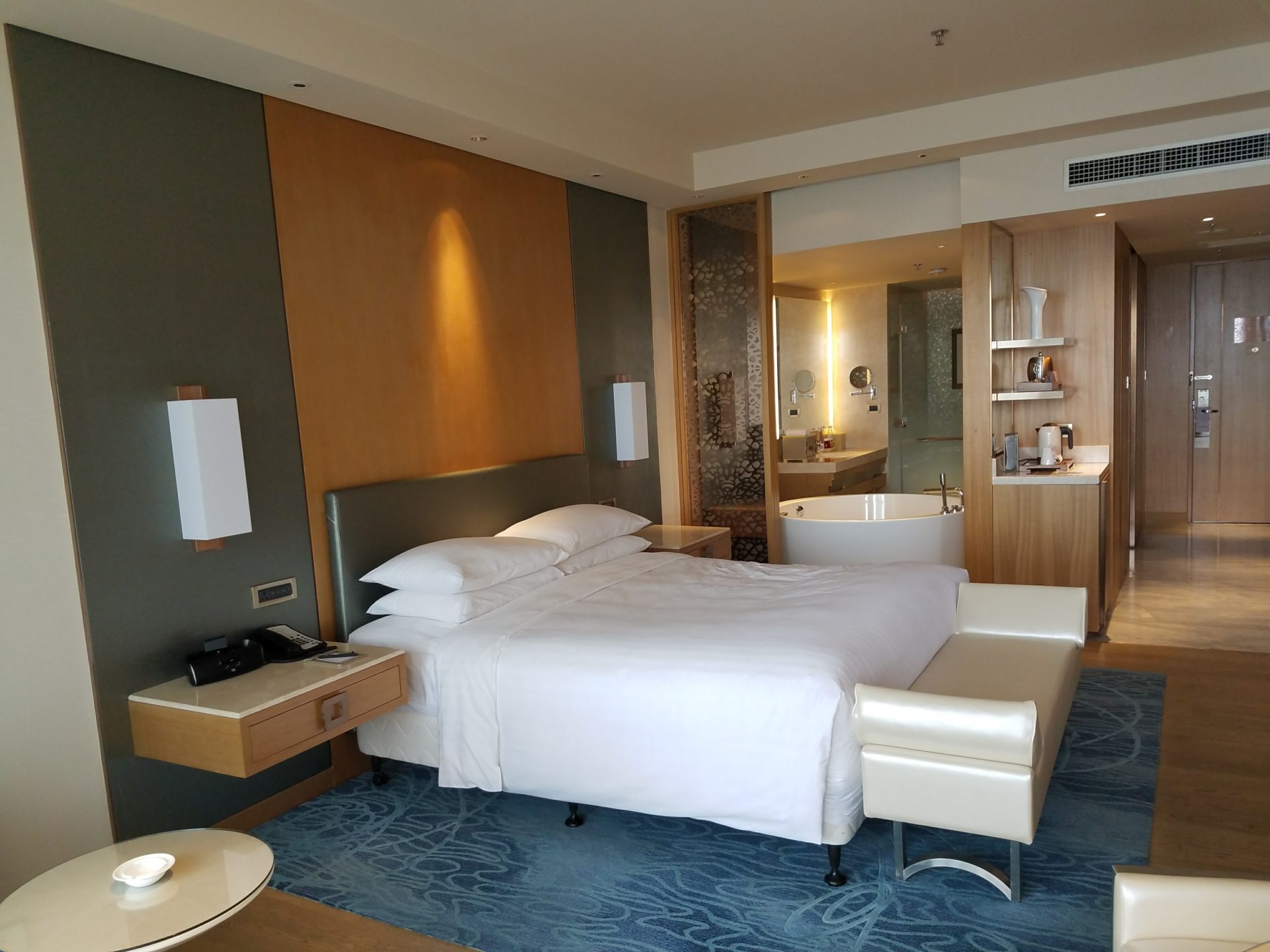 a hotel room with a bed and bathtub