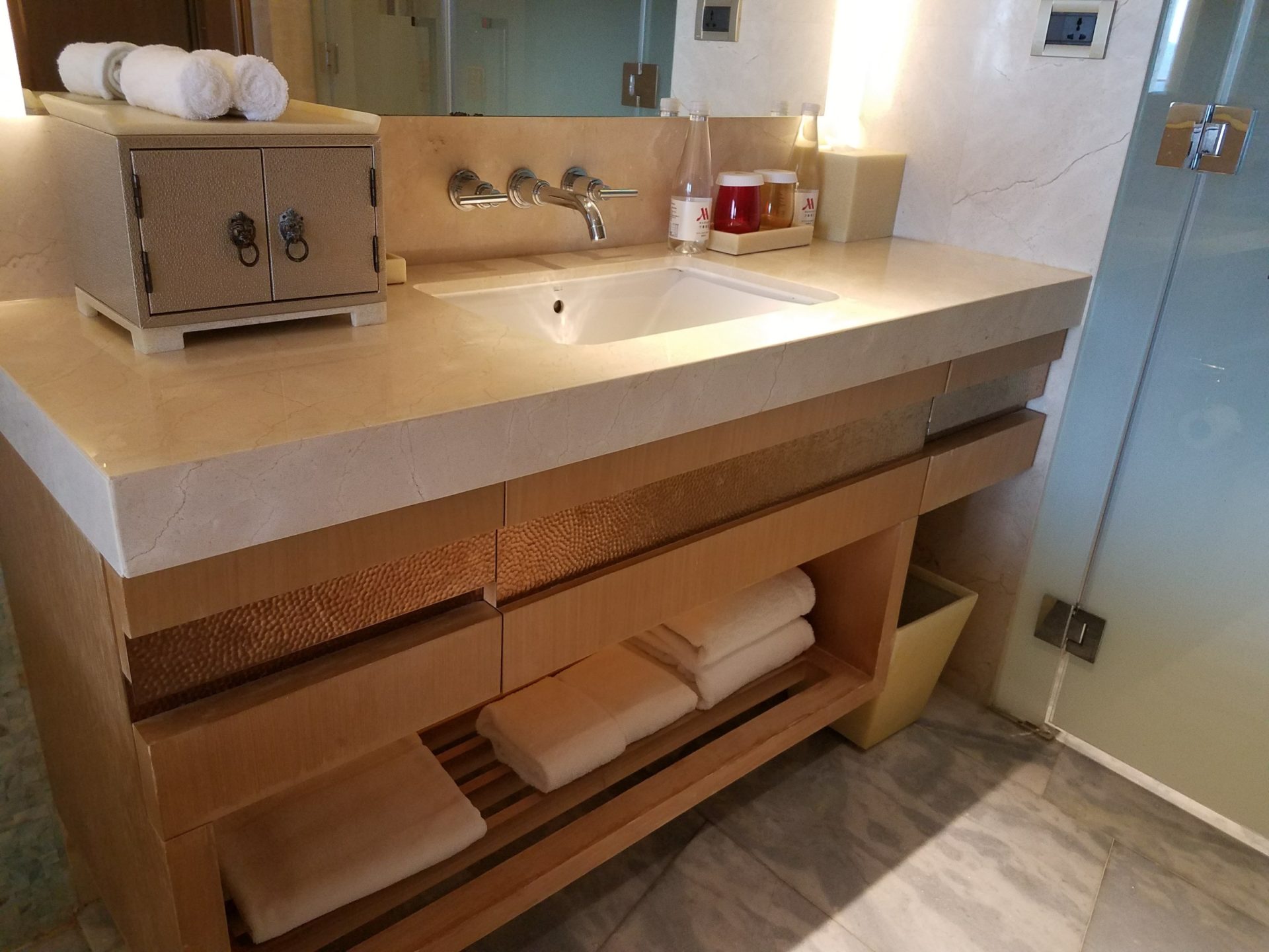 a bathroom sink with towels and a mirror