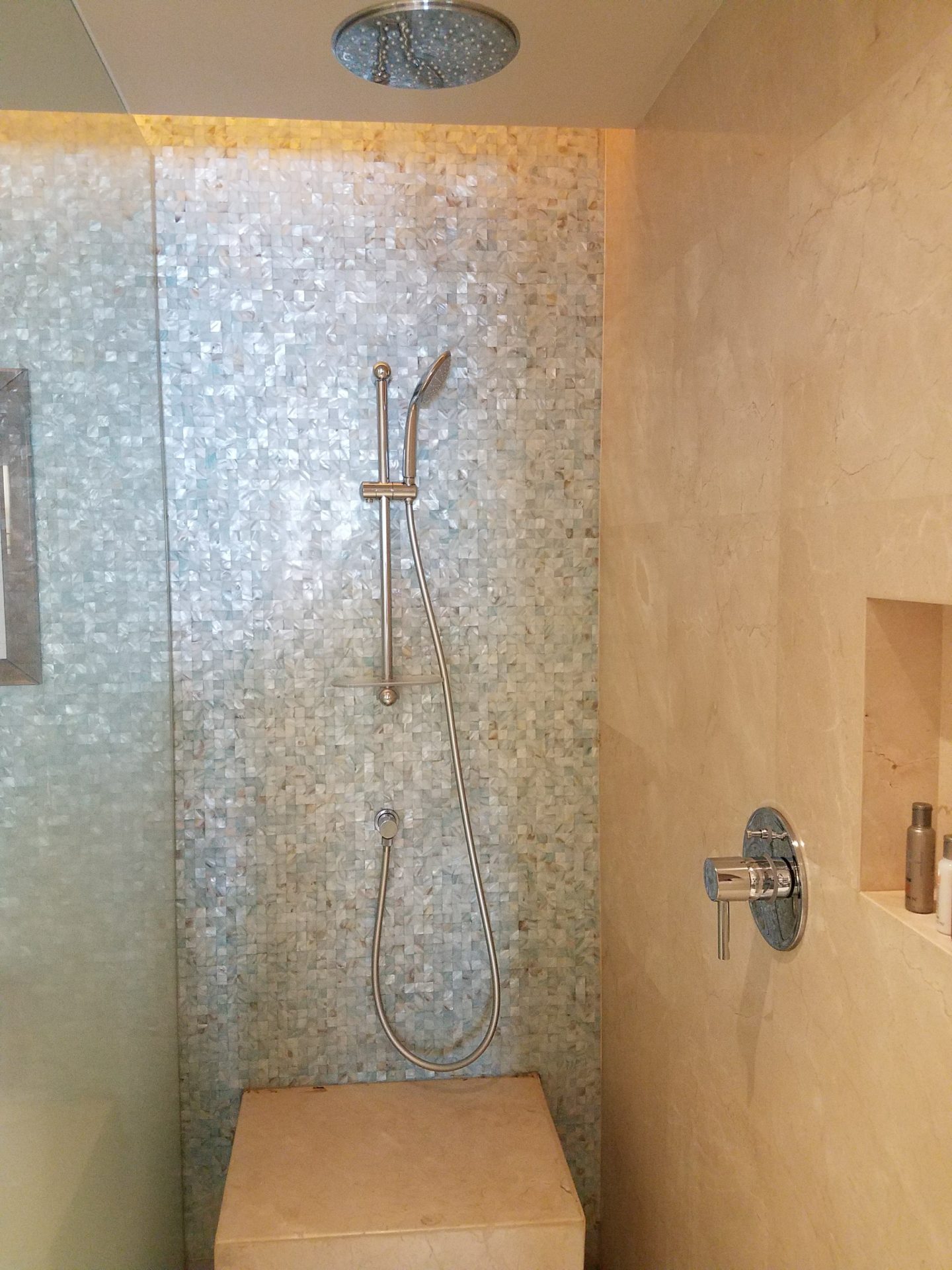 a shower with a hose and a shower head