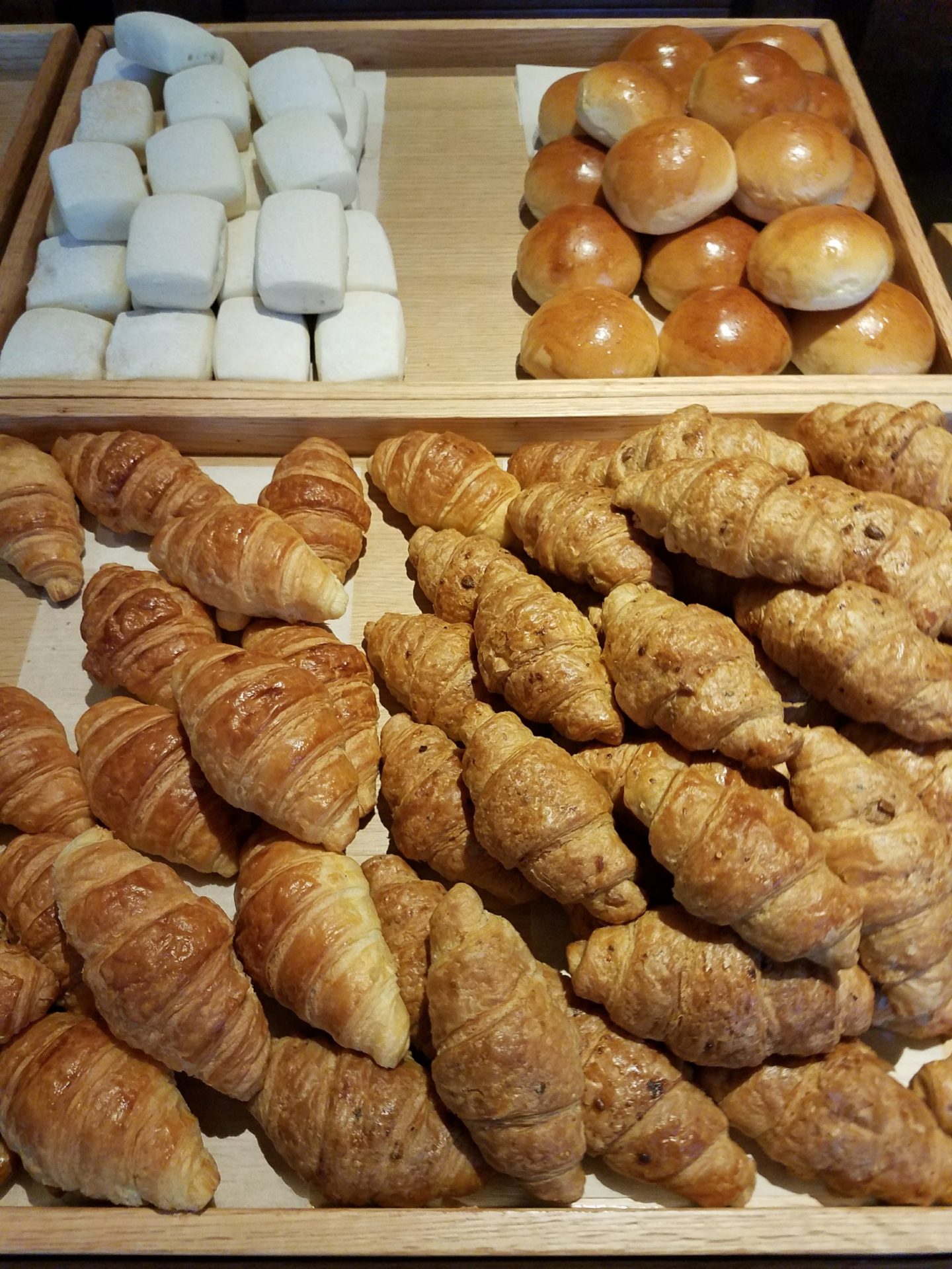 a tray of croissants and rolls