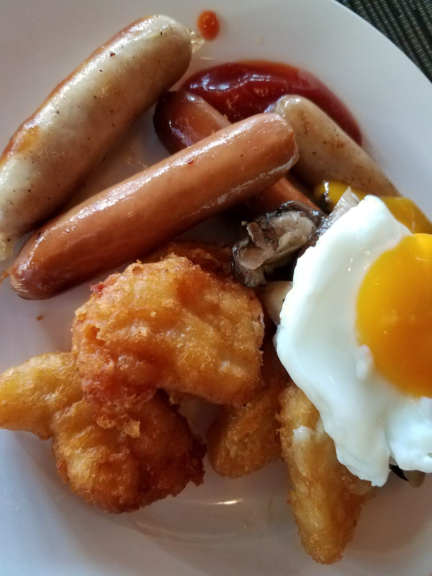 a plate of food with a fried egg and sausage