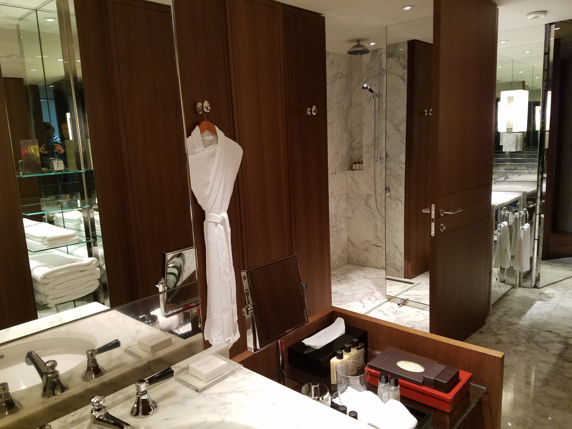 a bathroom with a white robe on a hook