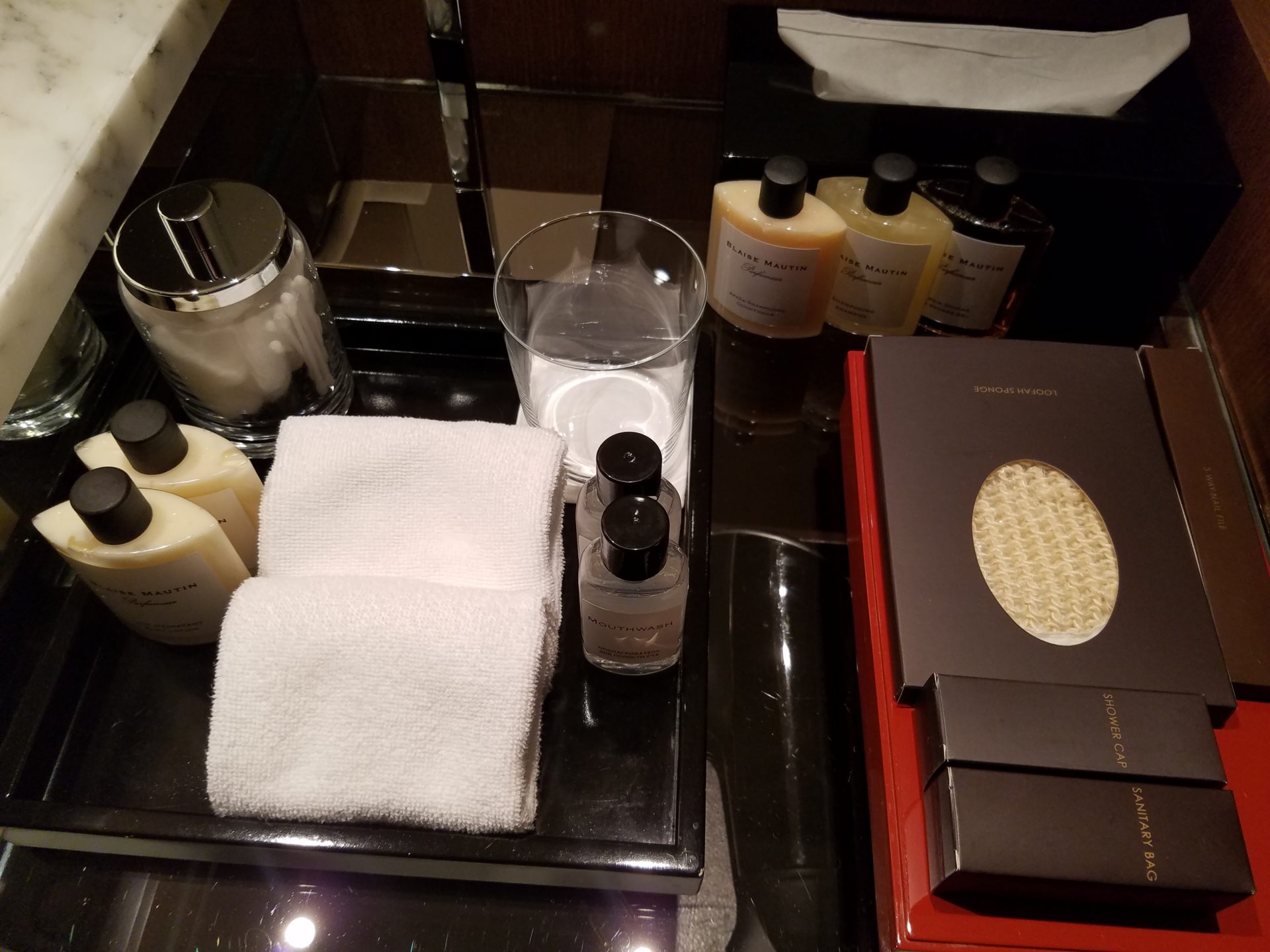 a group of toiletries and towels on a counter