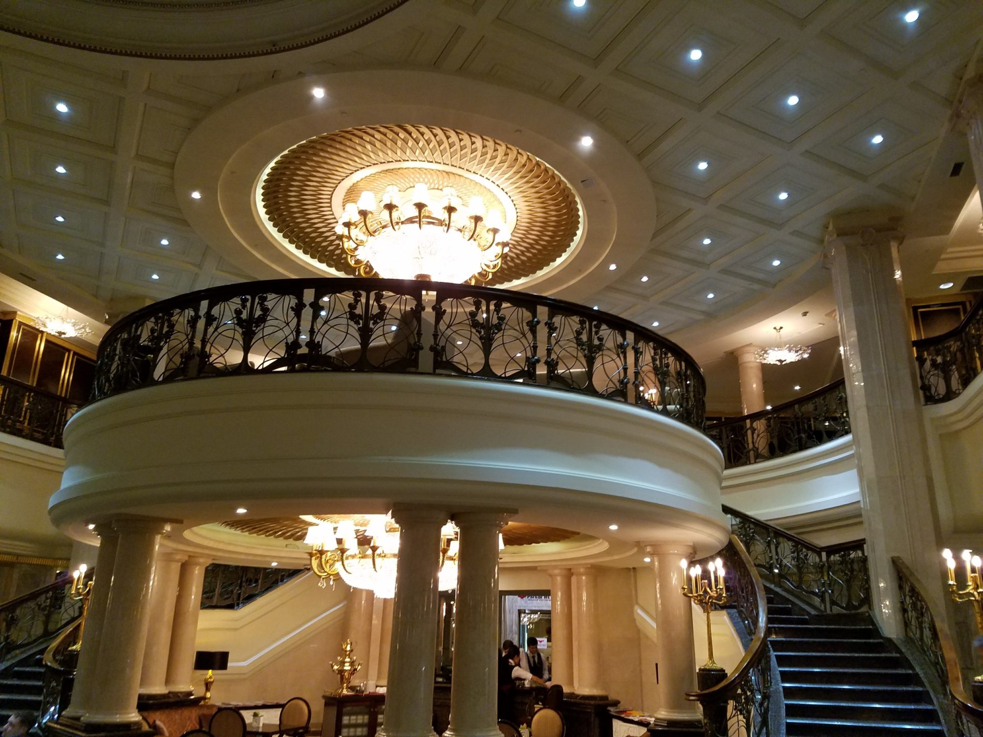 a large staircase with a chandelier and a chandelier