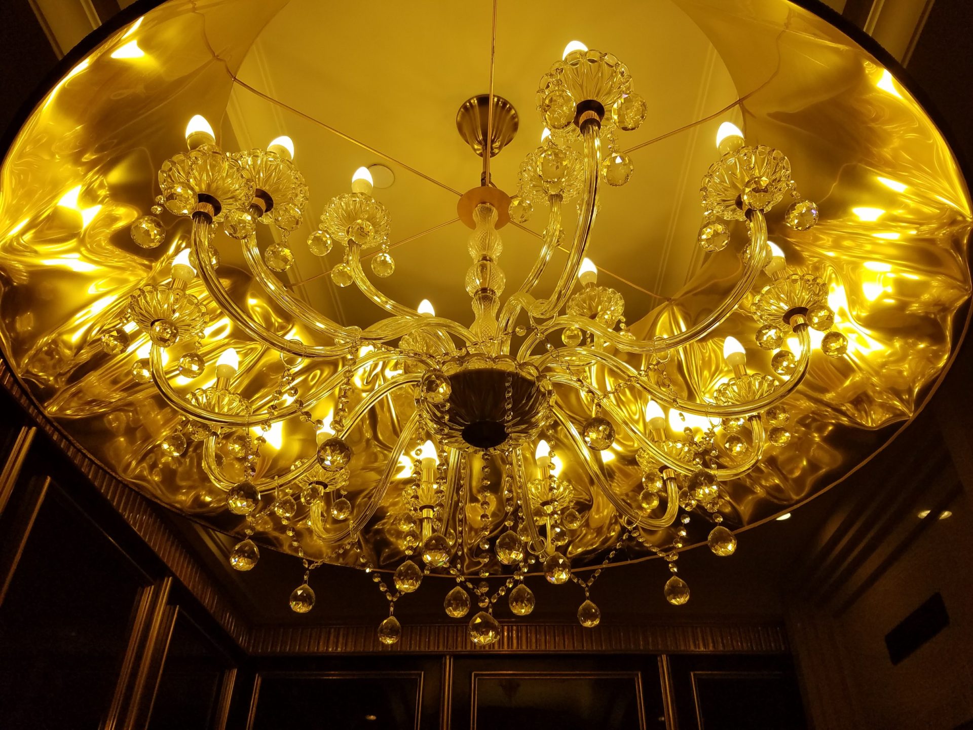 a chandelier with crystal lights from the ceiling