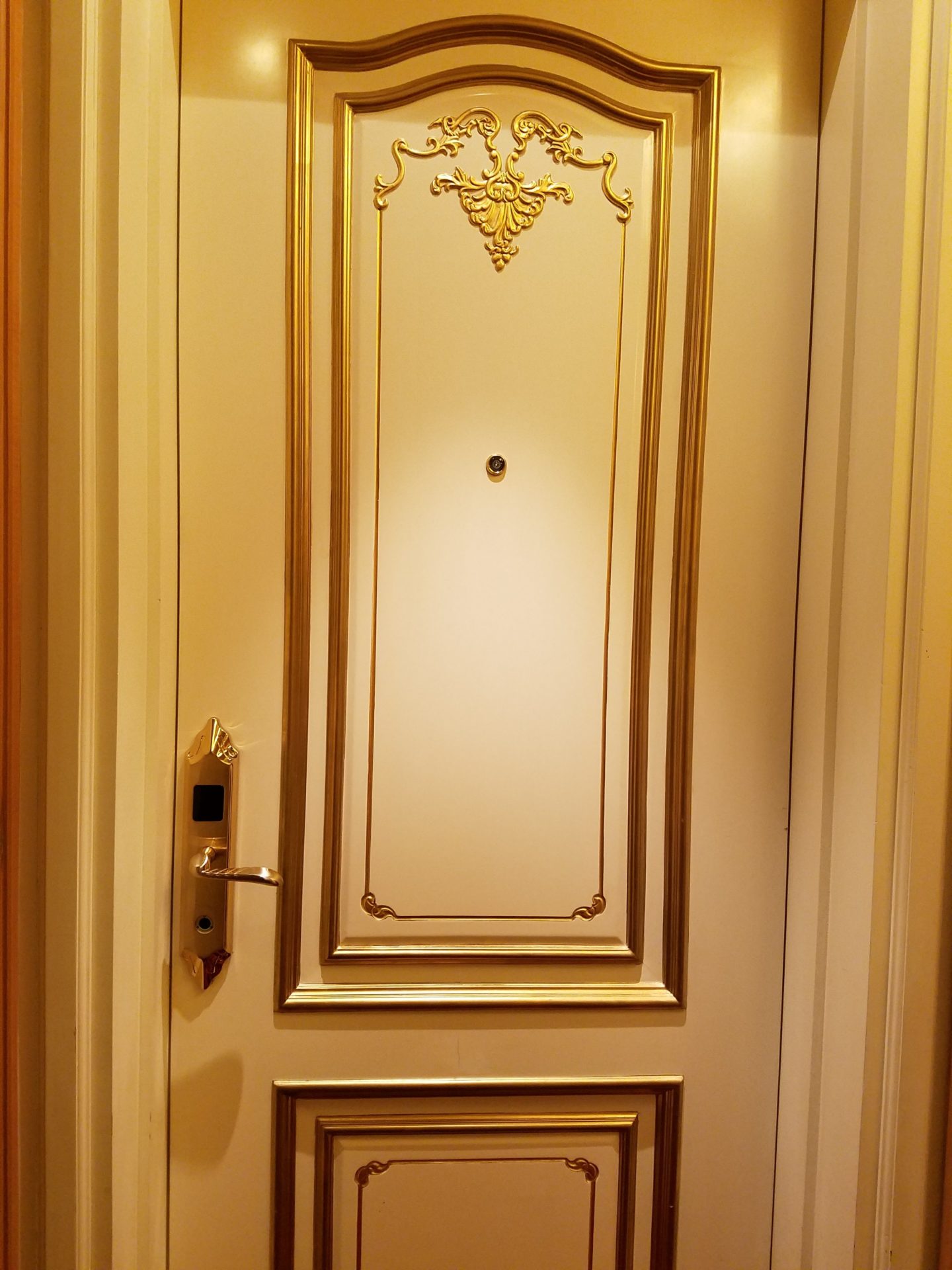 a white door with gold trim