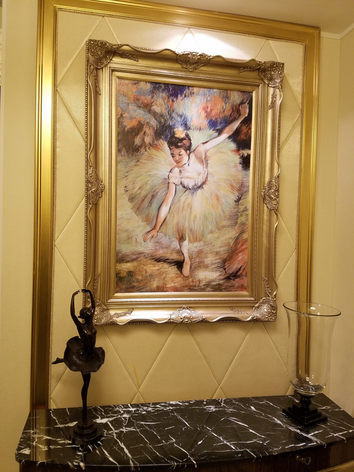 a framed picture of a ballerina on a wall