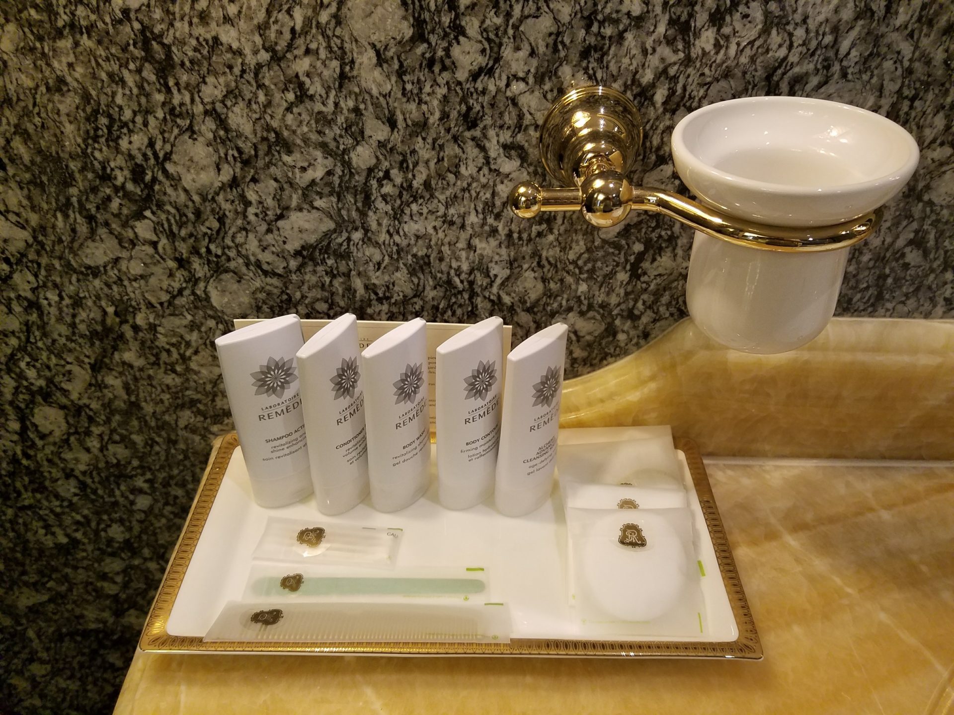 a tray with toiletries and a gold handle