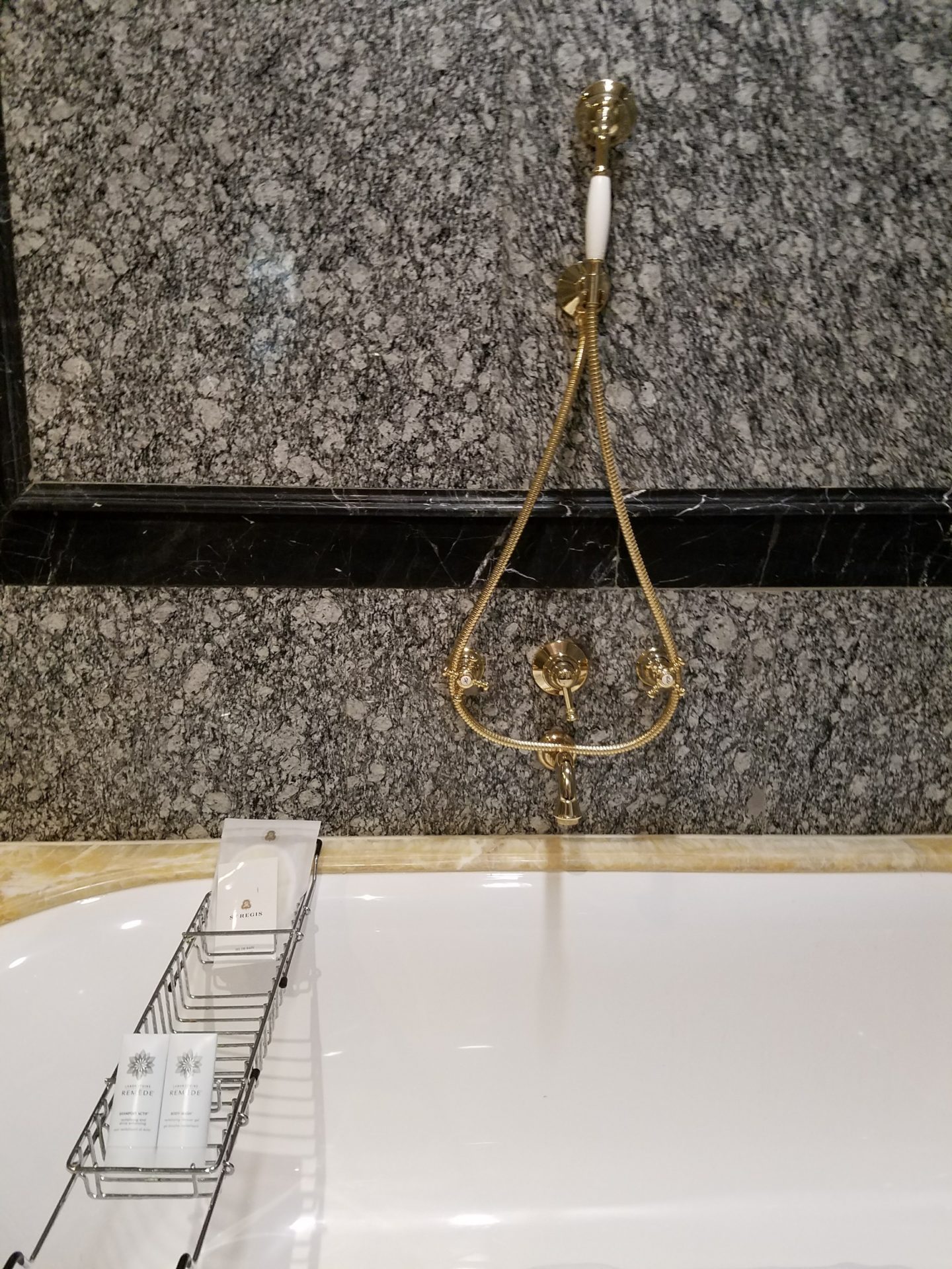 a bathtub with a gold rope from it
