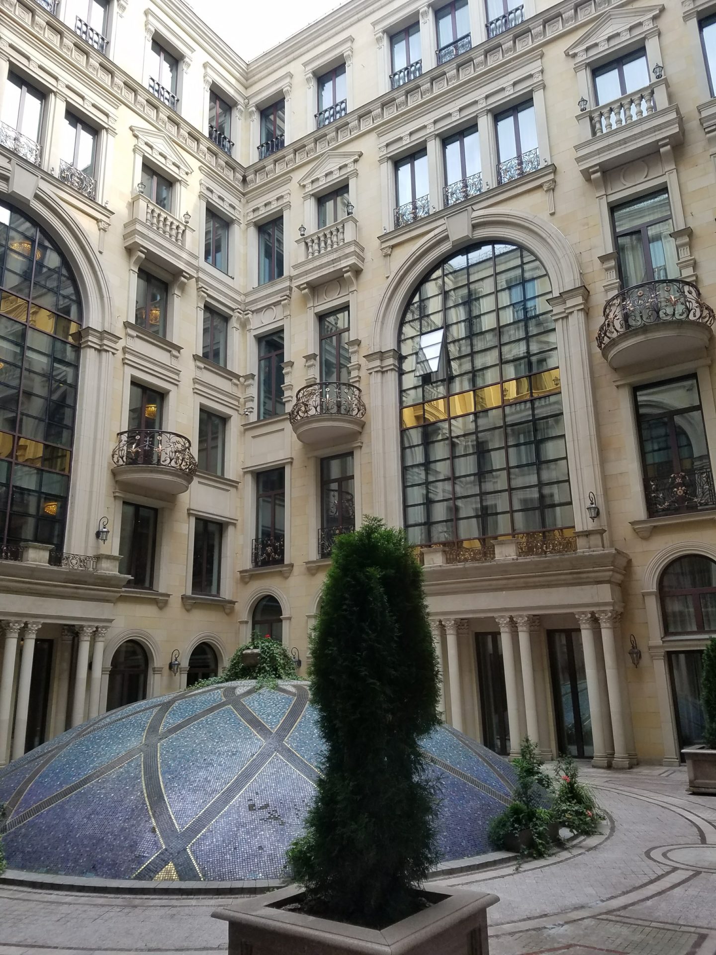 a courtyard of a building with a glass dome