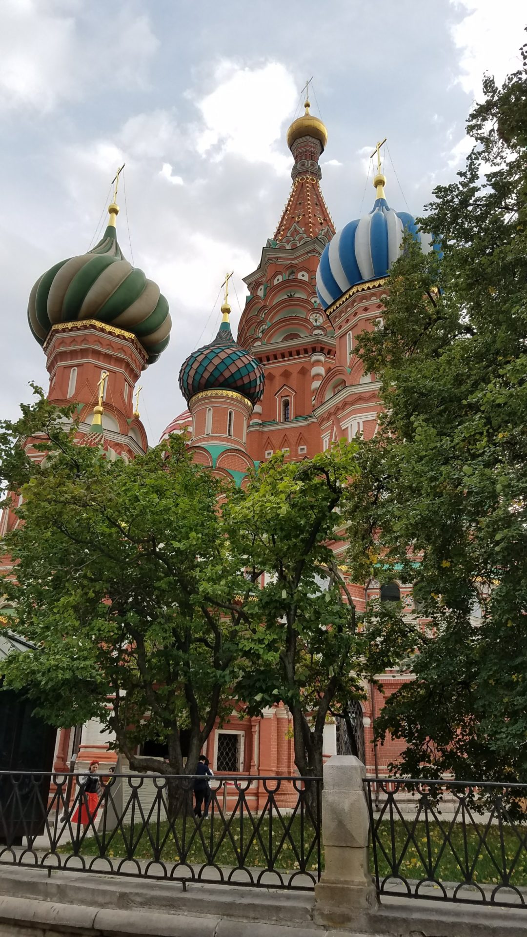 a building with colorful domes and trees