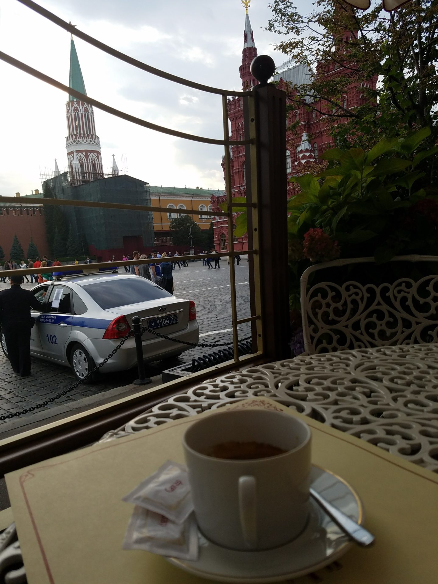 a cup of coffee on a table outside a window