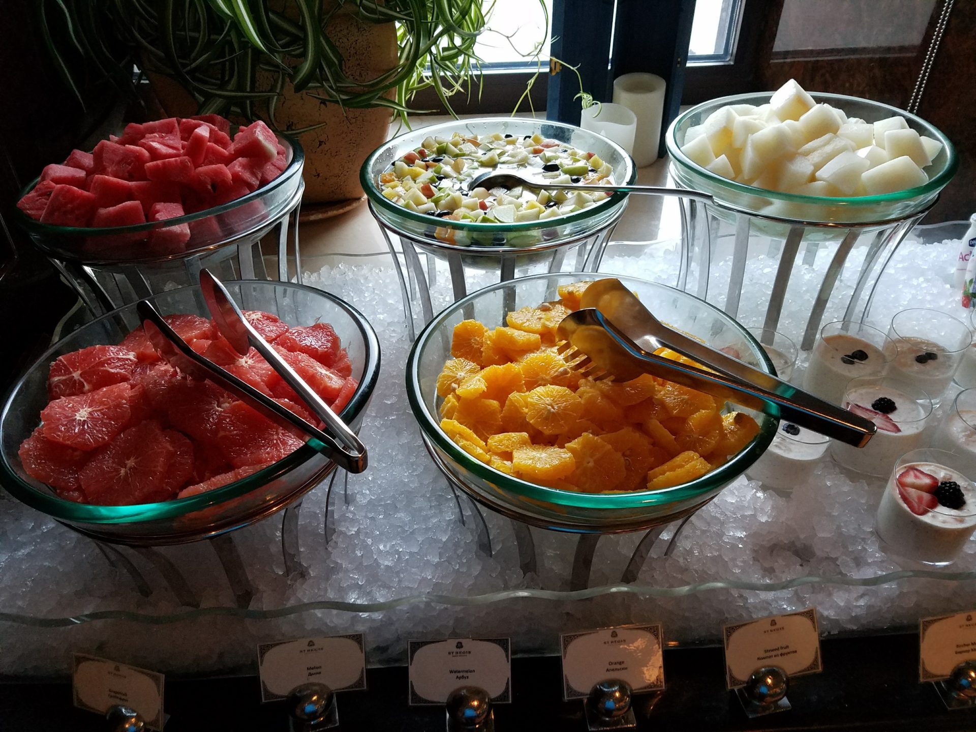 a group of bowls of fruit on ice