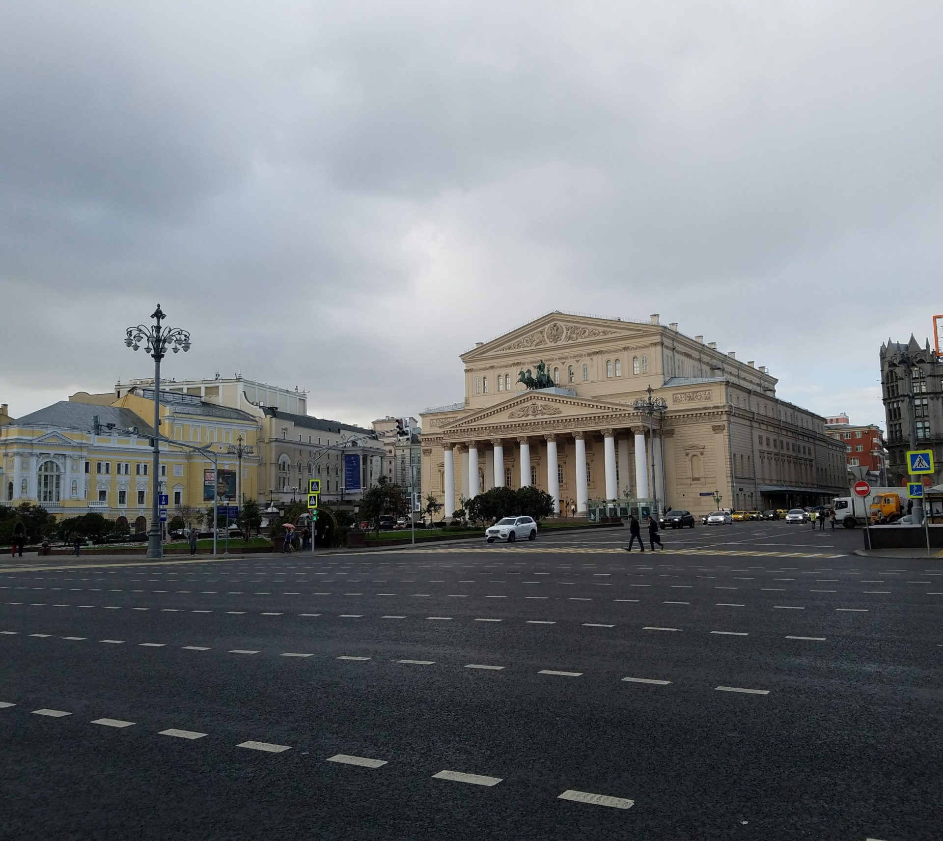 a large building with columns and a street in the background