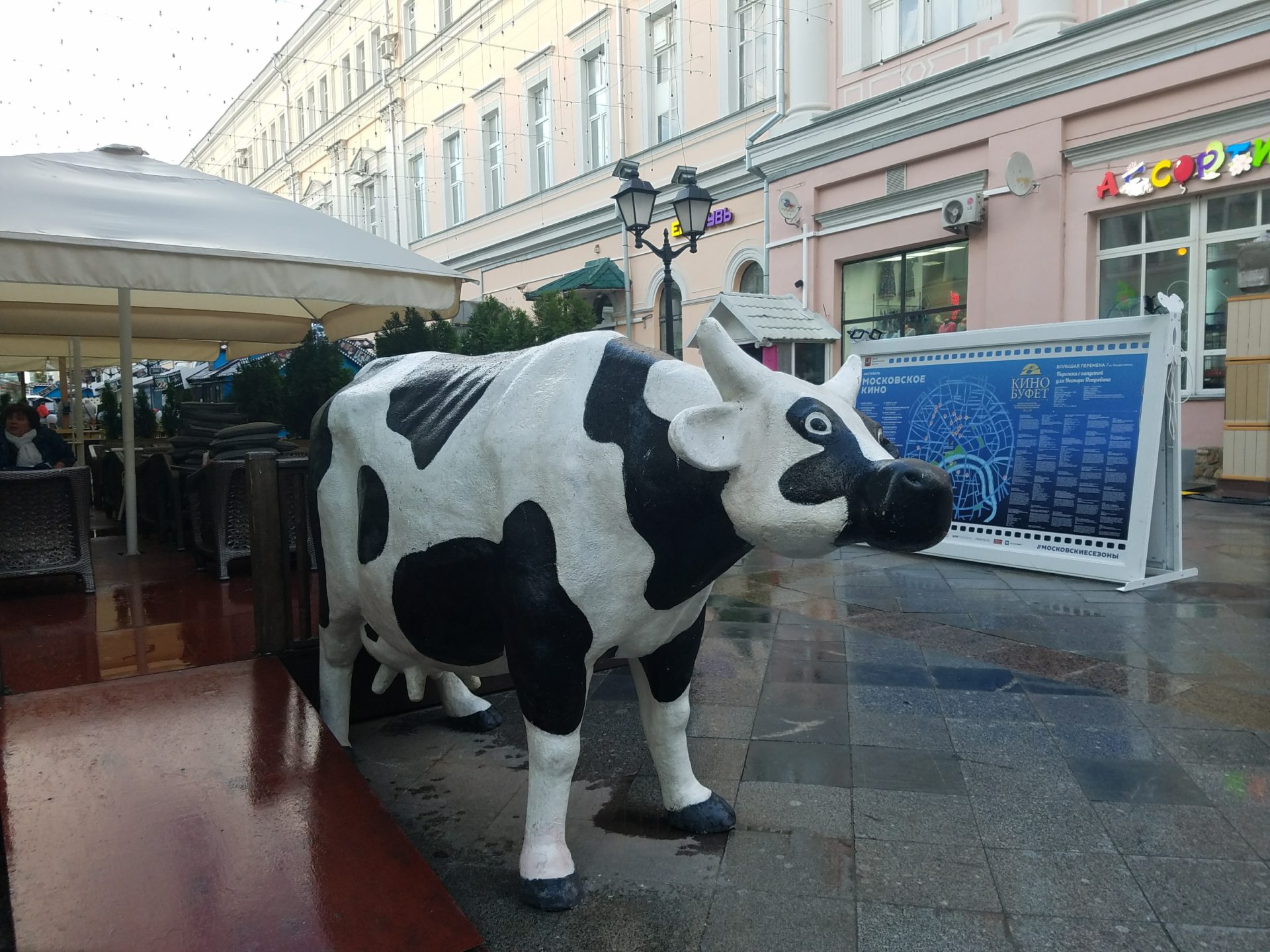 a statue of a cow on a sidewalk